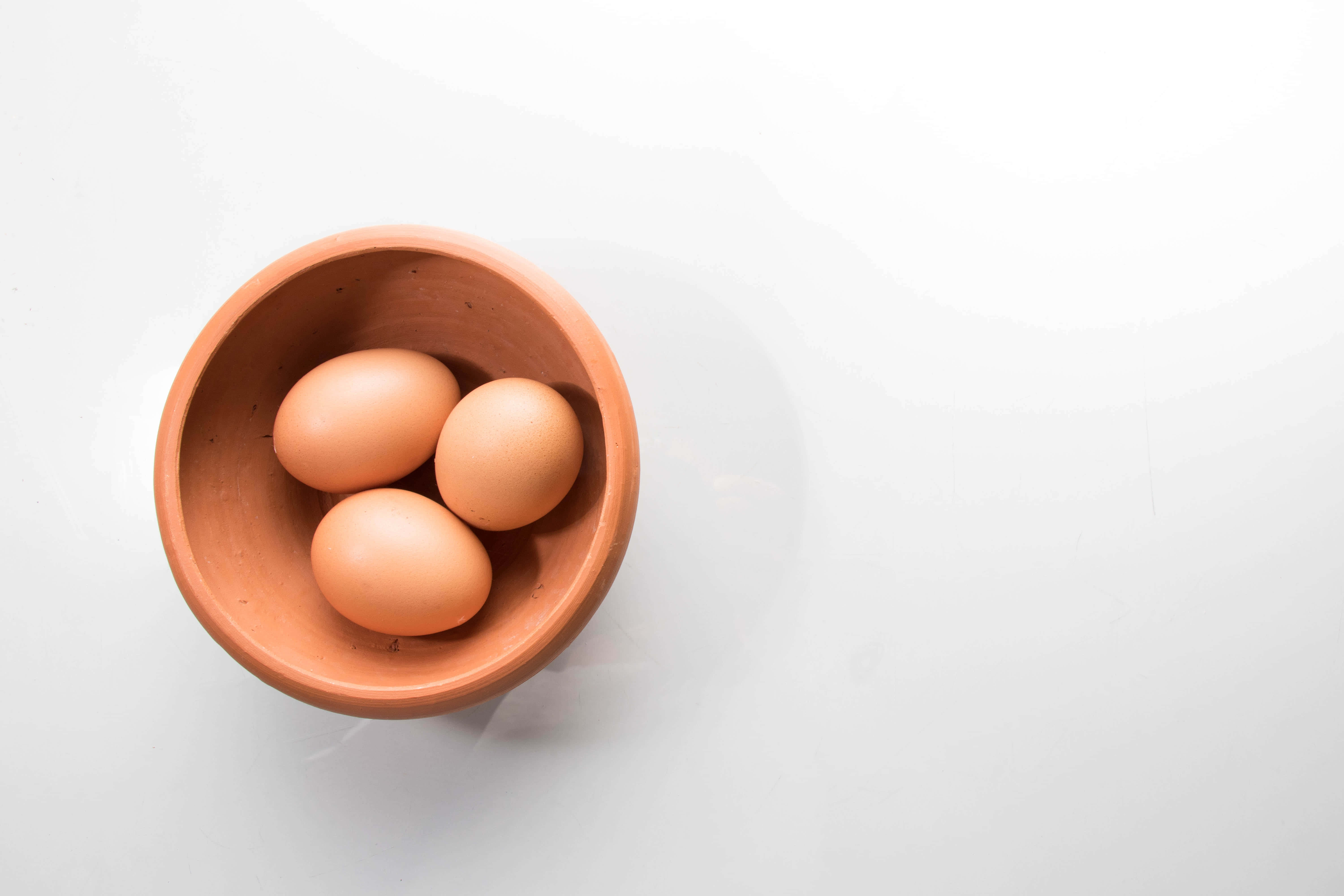 brown eggs, terracotta bowl, wooden surface, 5K Desktop Wallpaper