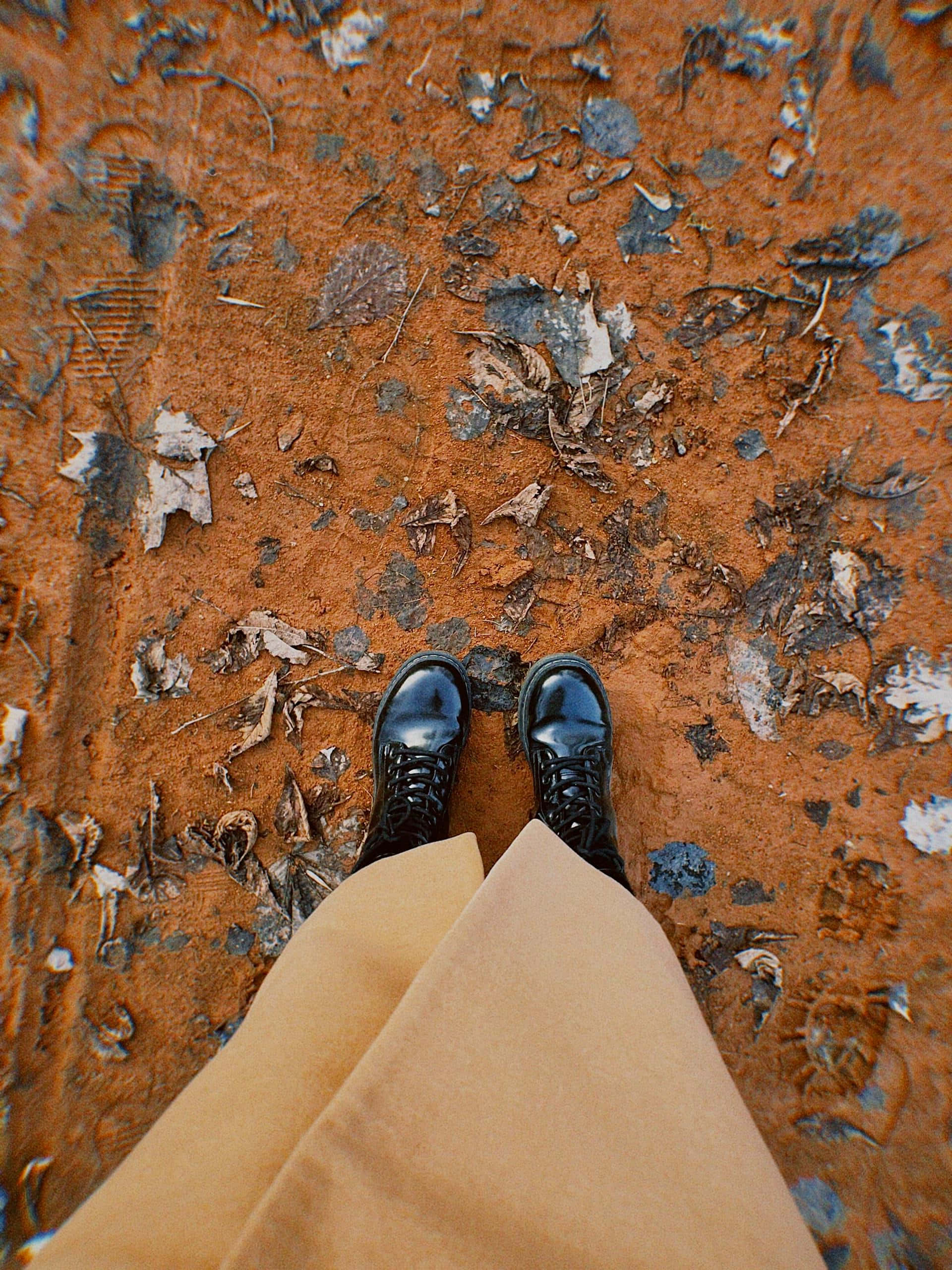black lace-up boots, tan pants, orange-red earth, 2K Phone Wallpaper