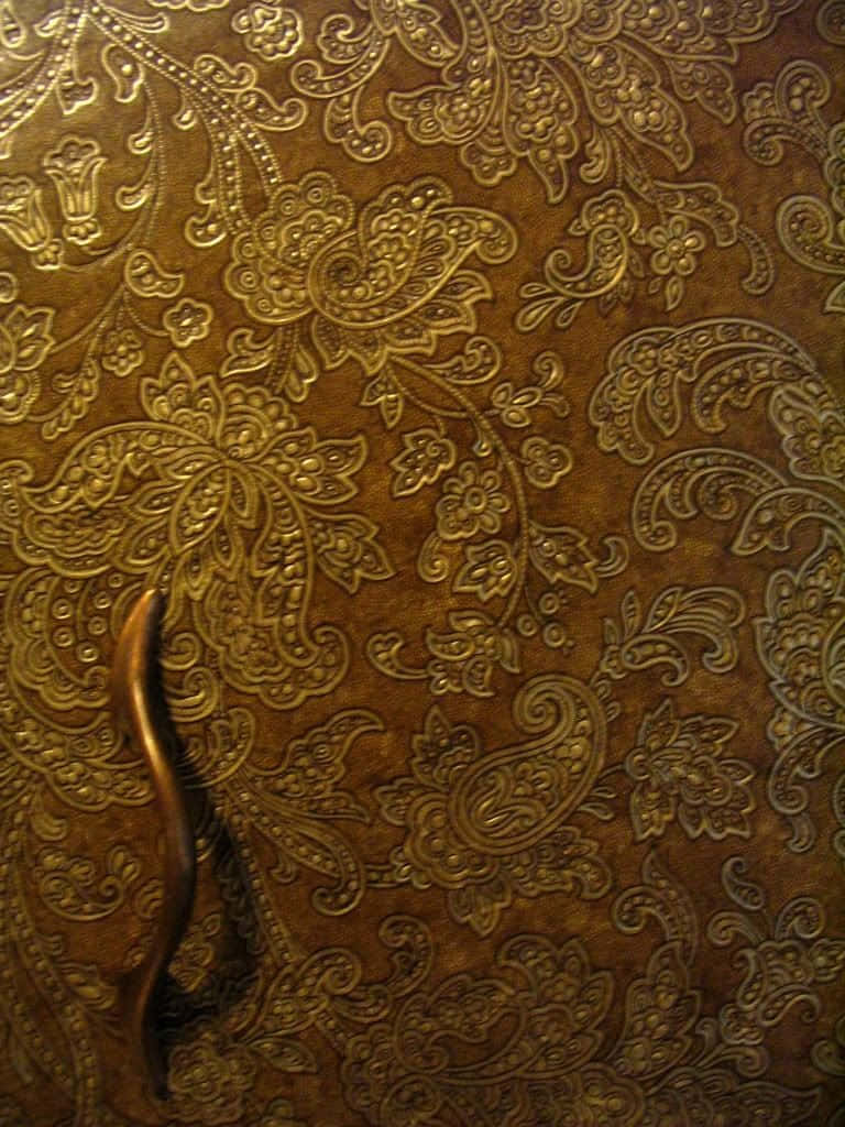 brown leather, gold embossed paisley patterns, curved metallic handle, SD Phone Wallpaper