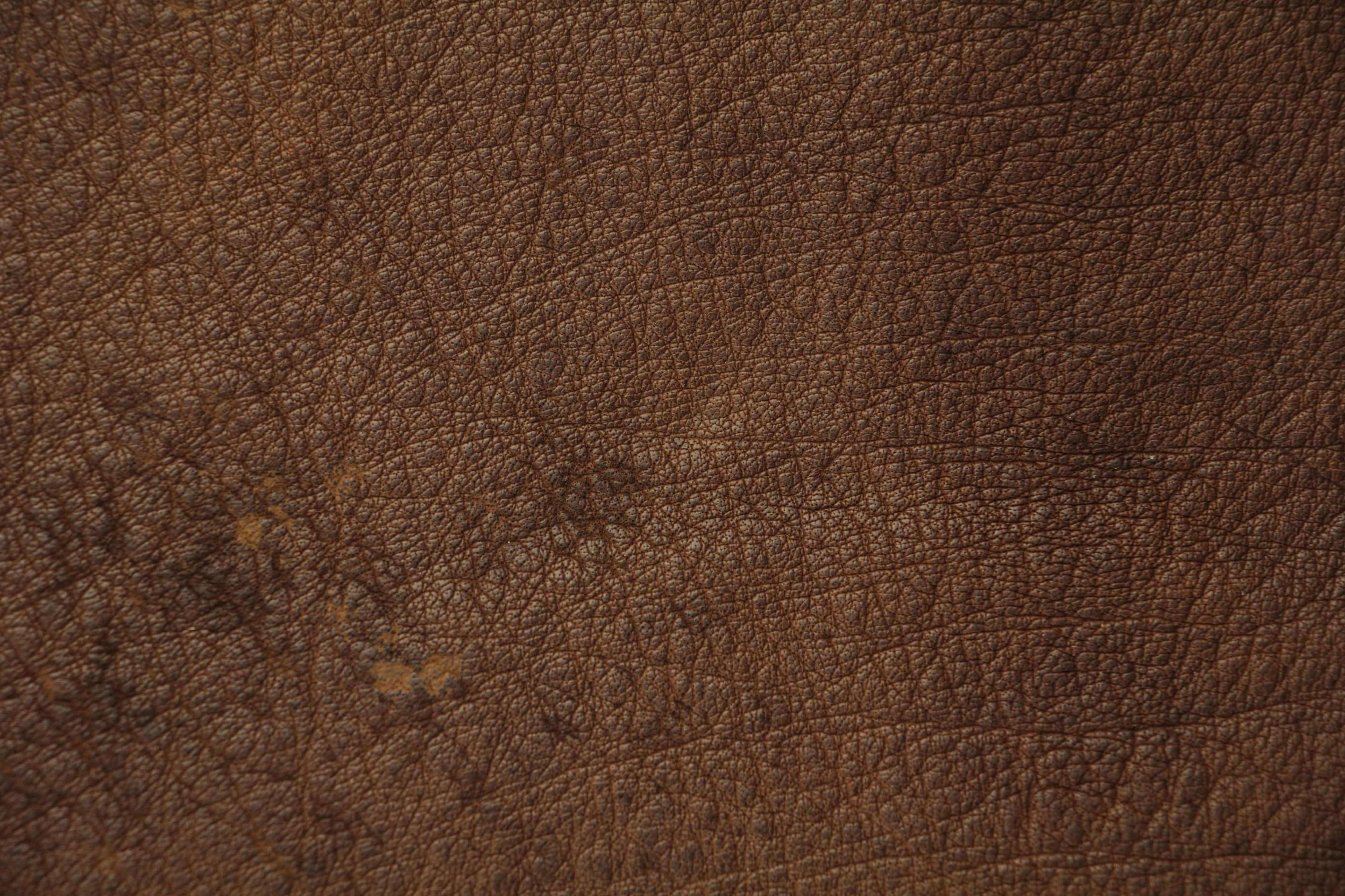 dark brown leather, natural grain texture, subtle wear marks, 4K Desktop Wallpaper
