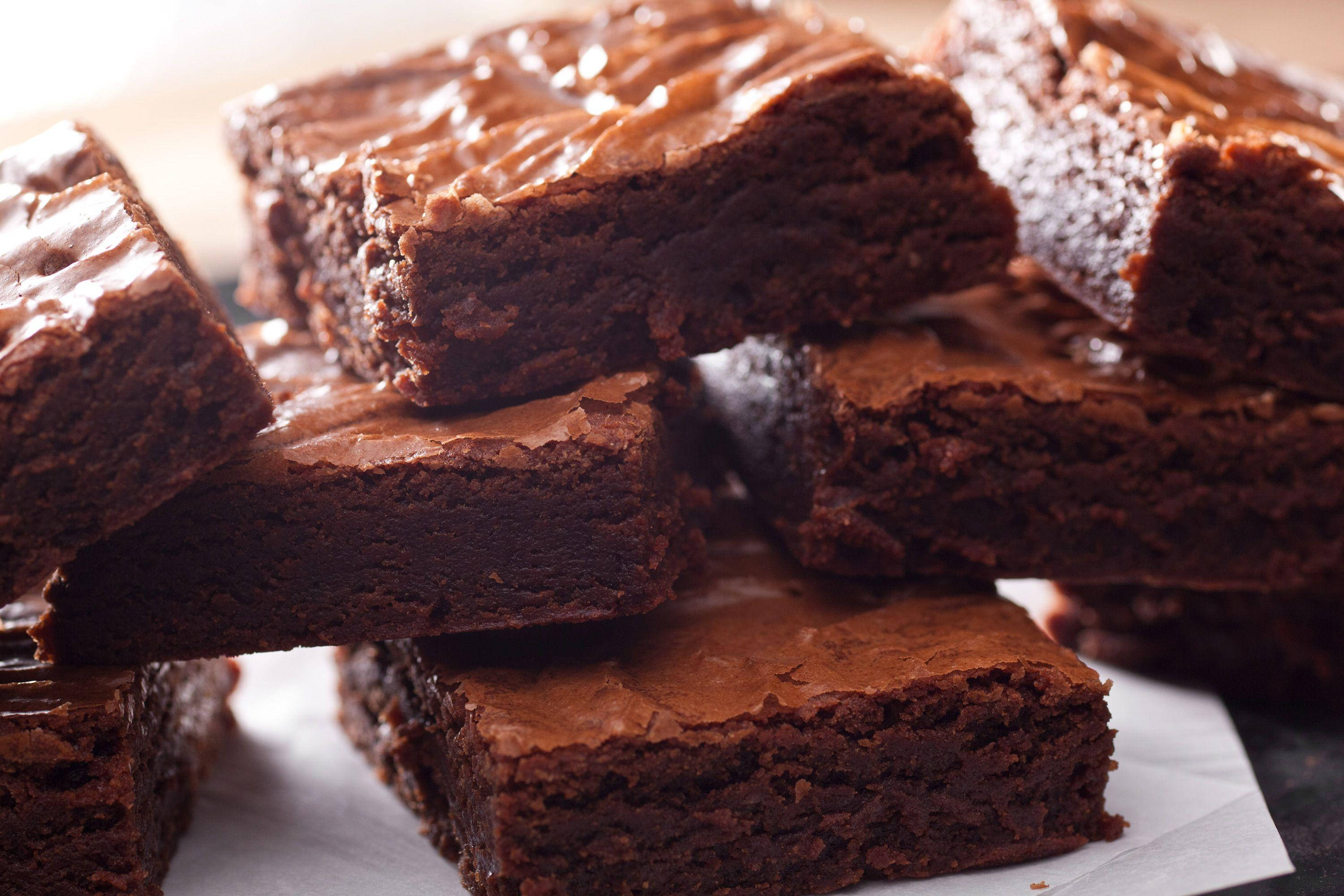 yummy stacked brownies, glossy chocolate frosting, parchment paper, 2K Desktop Wallpaper