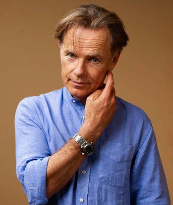 Bruce Greenwood, blue button-down shirt, warm brown backdrop, SD Phone Wallpaper