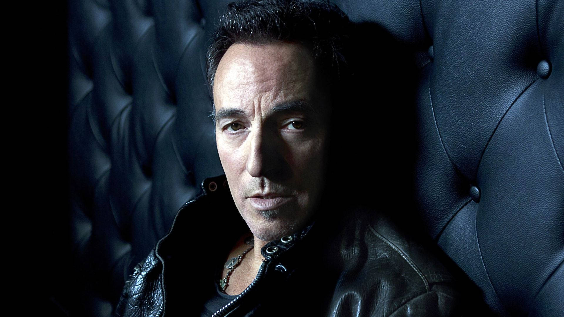 Bruce Springsteen, leather jacket, dark tufted leather chair, Full HD Desktop Wallpaper