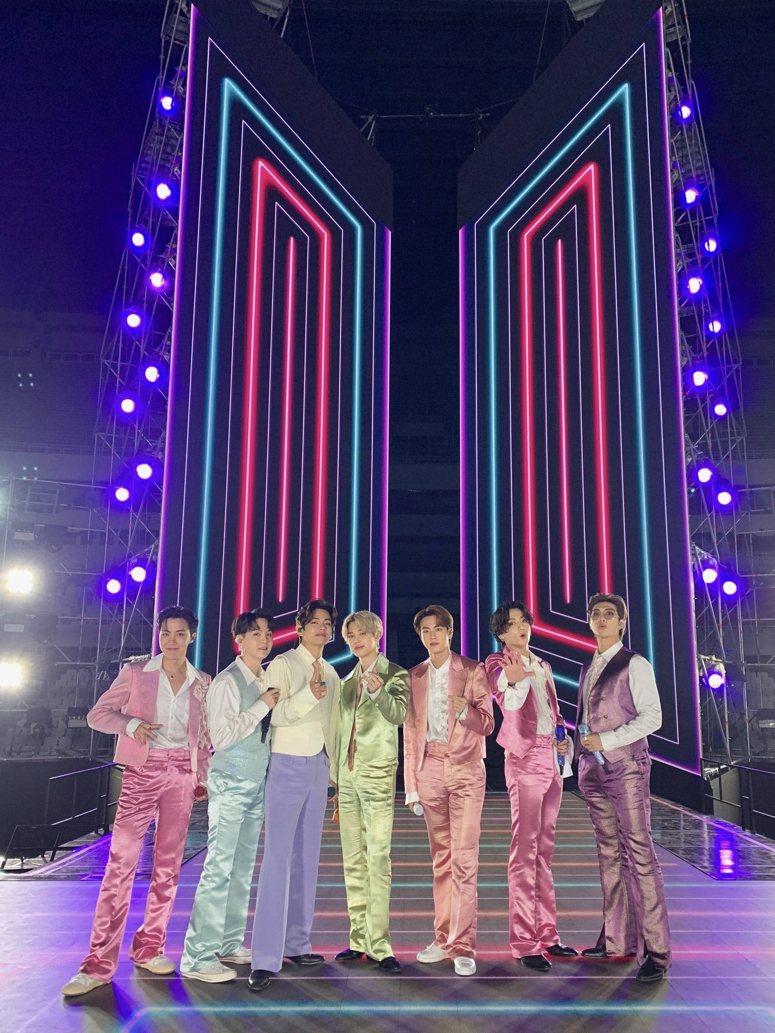 BTS Dynamite, neon-lit stage, glowing pink and blue geometric panels, Full HD Phone Wallpaper