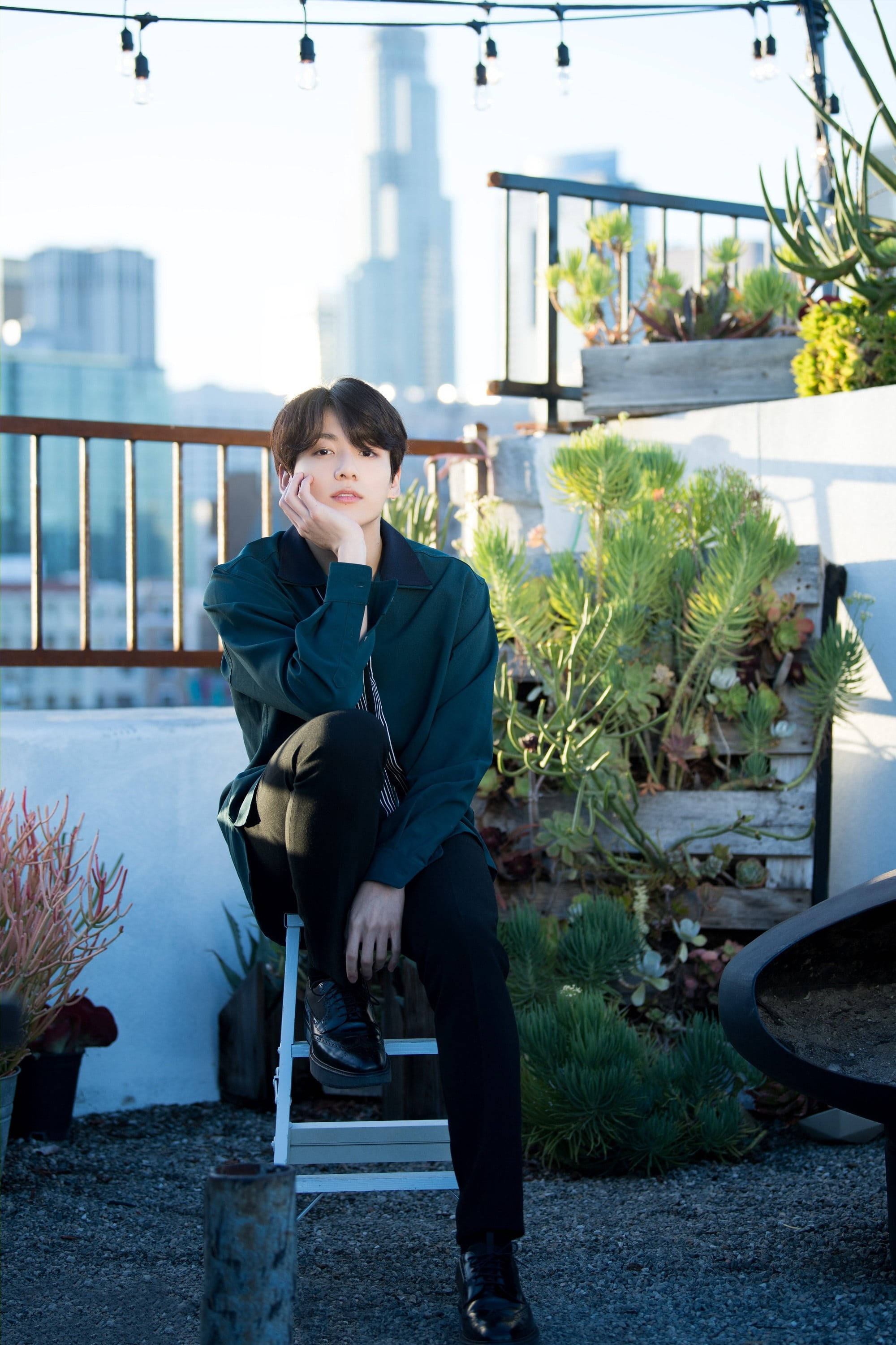 BTS Jung Kook, dark green jacket, white stool, 2K Phone Wallpaper