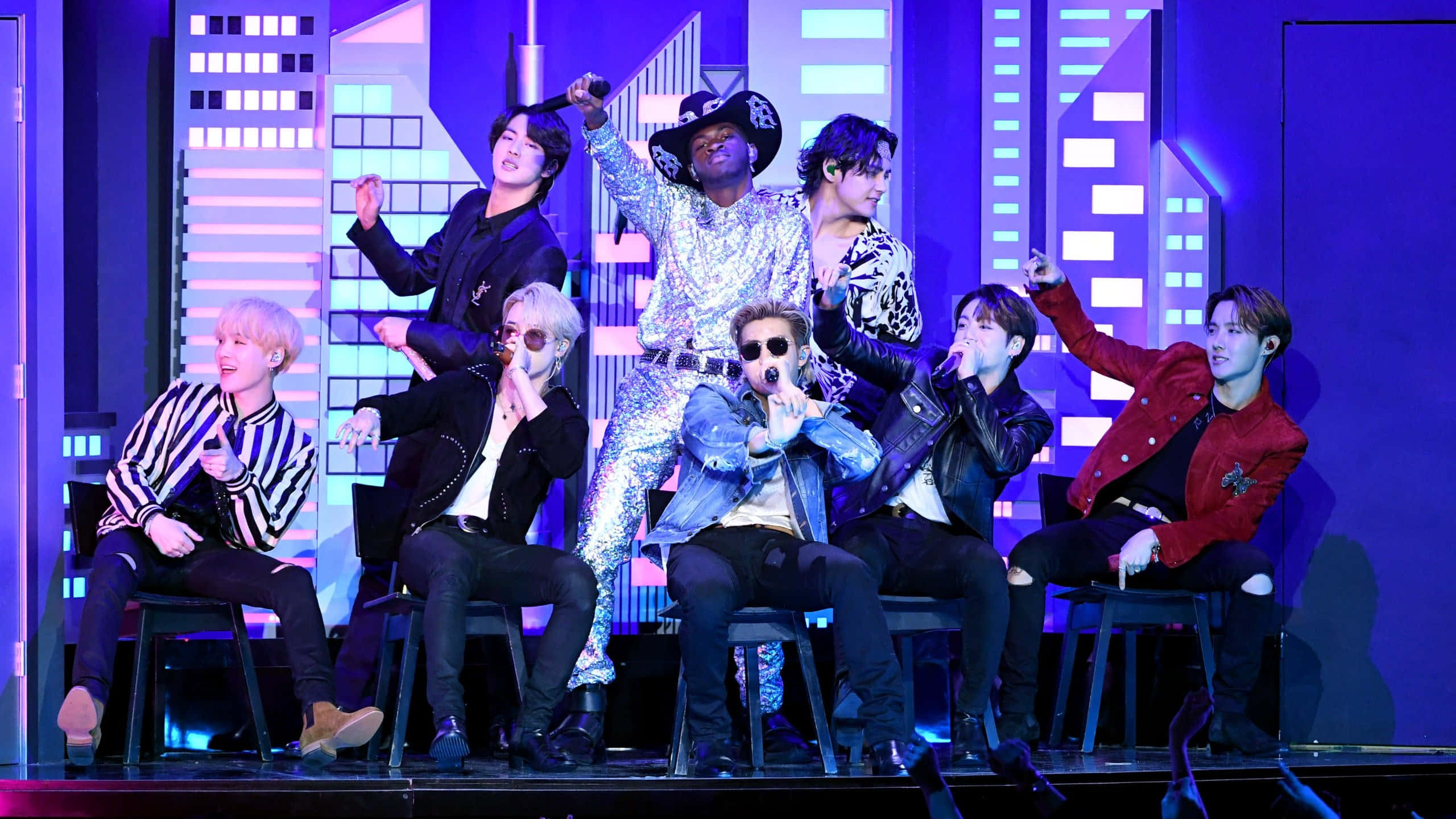 BTS, neon-lit stage, cityscape backdrop, 2K Desktop Wallpaper