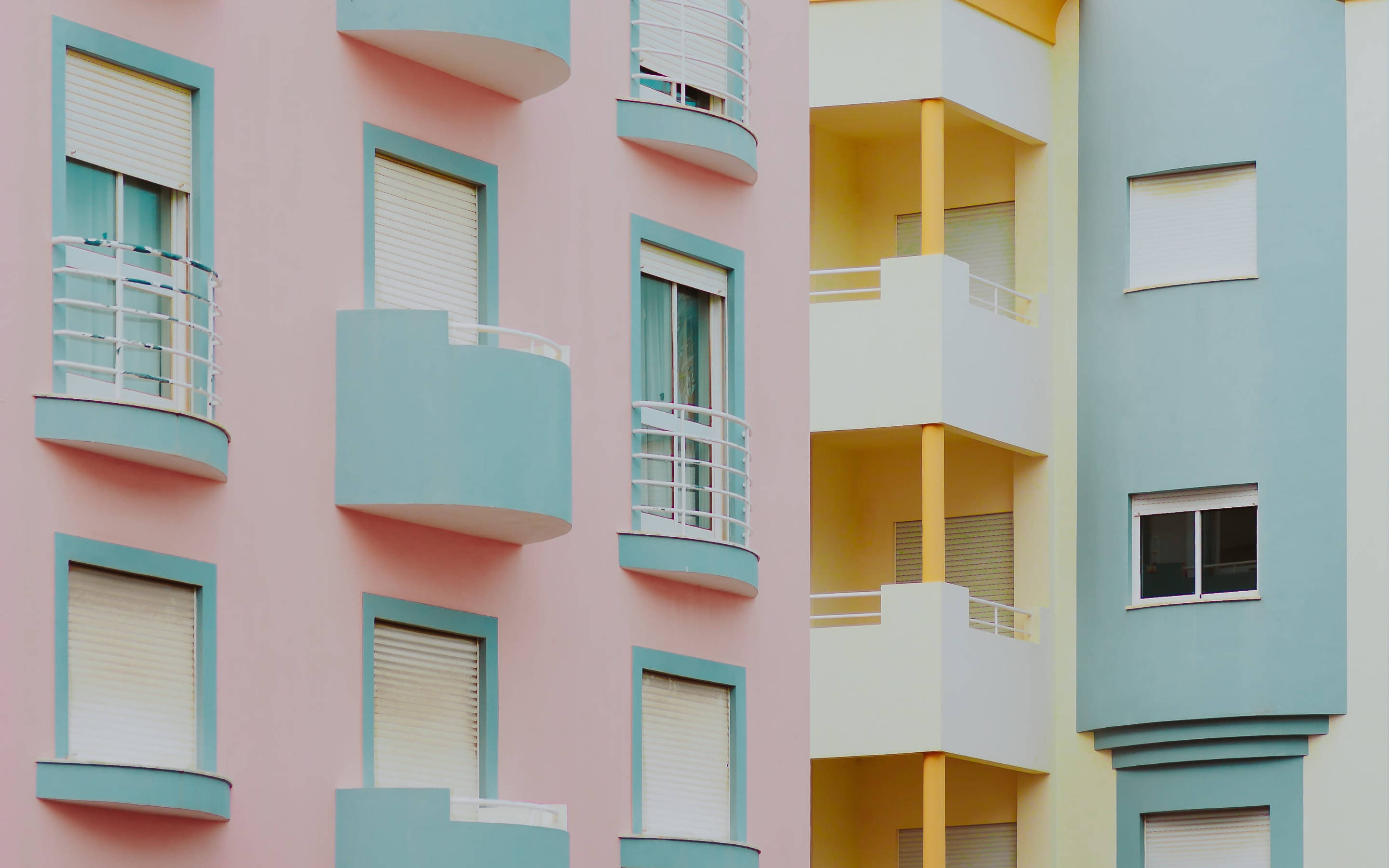 minimalist residential buildings, pastel colors, curved balconies, 2K Desktop Wallpaper