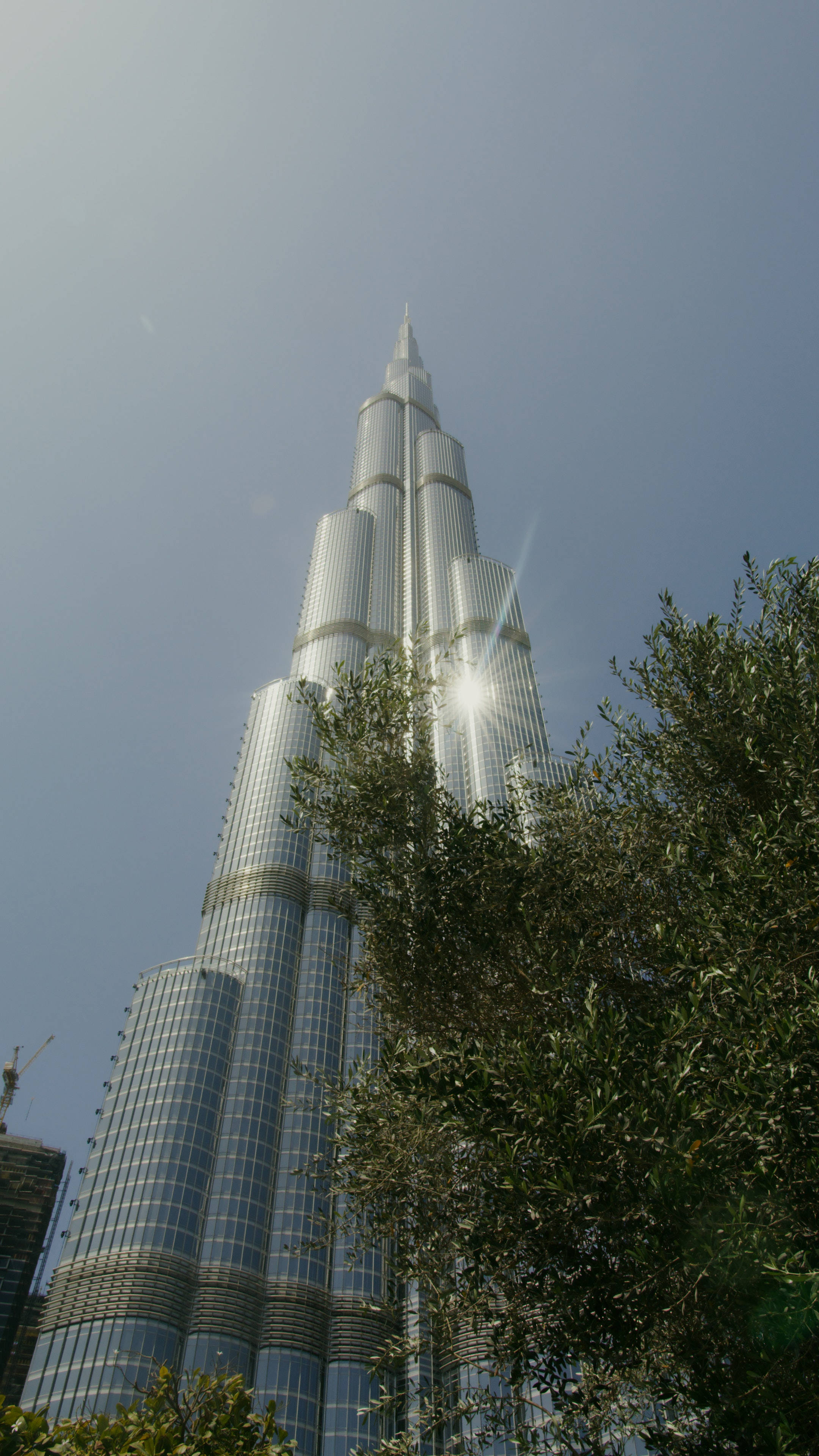 Burj Khalifa, clear blue sky, sun flares, 4K Phone Wallpaper