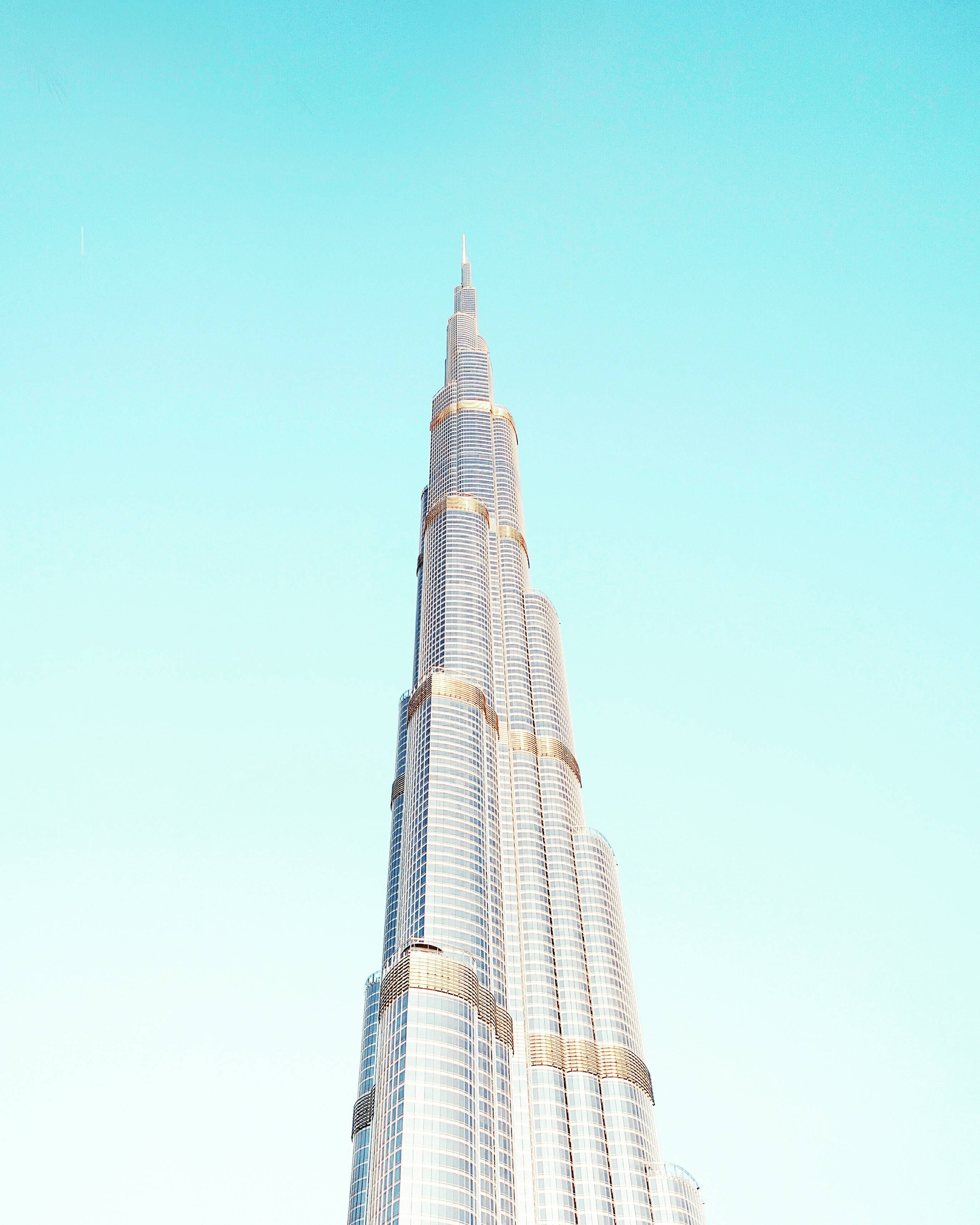 Burj Khalifa, glass and gold facade, clear turquoise sky, 2K Phone Wallpaper