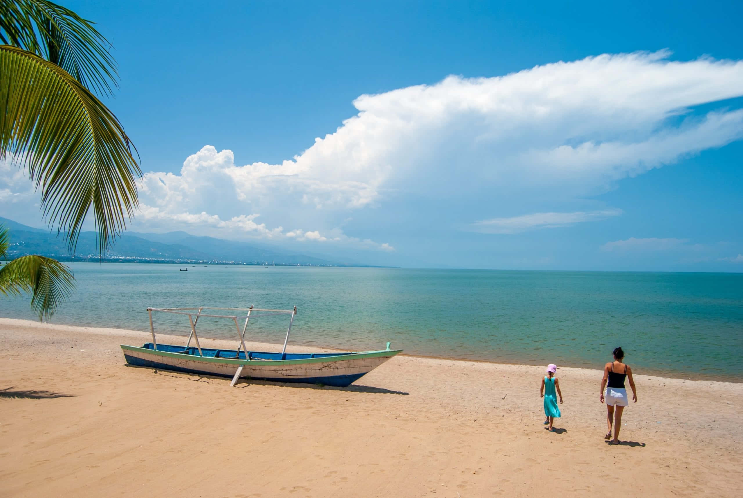 Burundi, sunlit beach, weathered boat, 2K Desktop Wallpaper