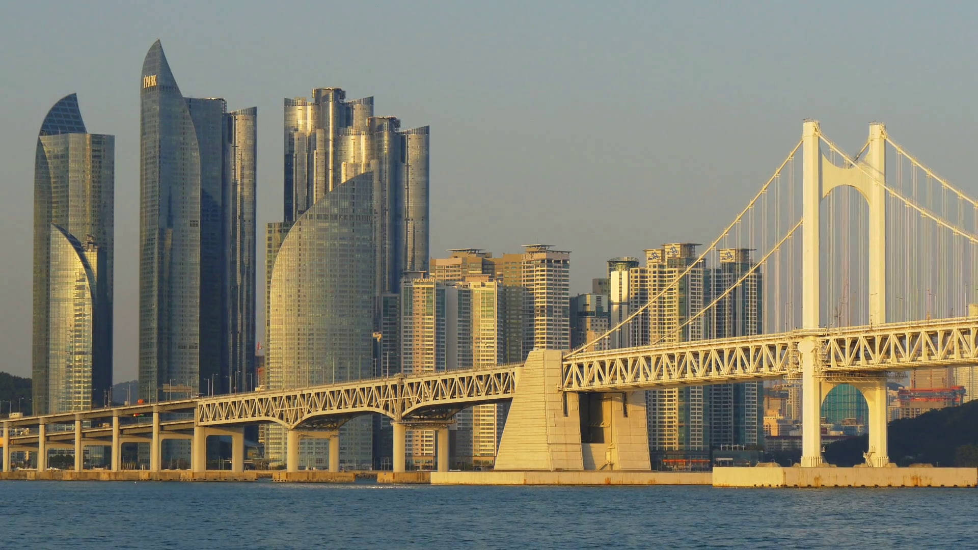 Busan, sleek glass skyscrapers, golden sunset light, Full HD Desktop Wallpaper