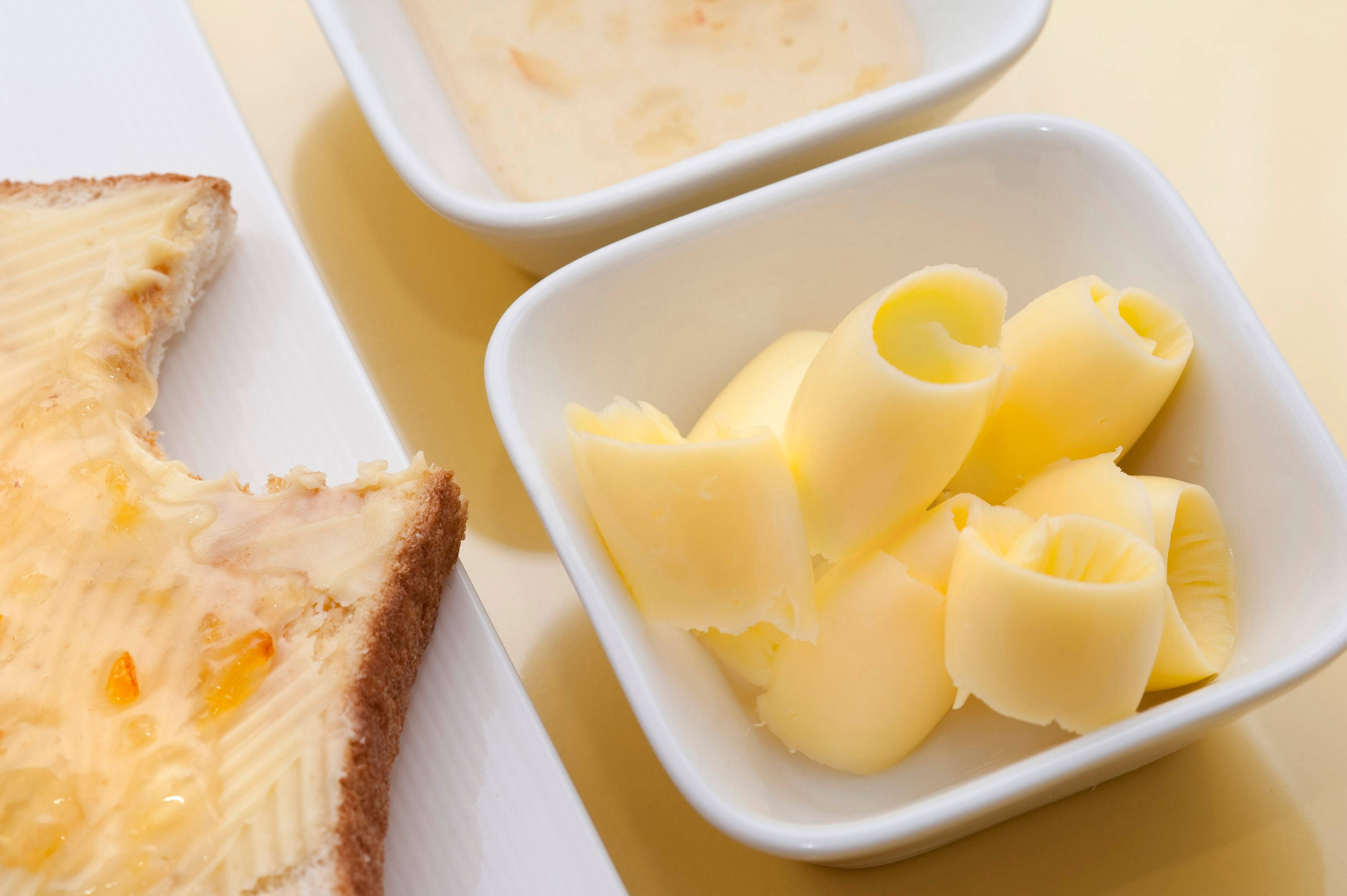 buttered toast, bowl of rolled butter curls, small dish of creamy spread, 2K Desktop Wallpaper