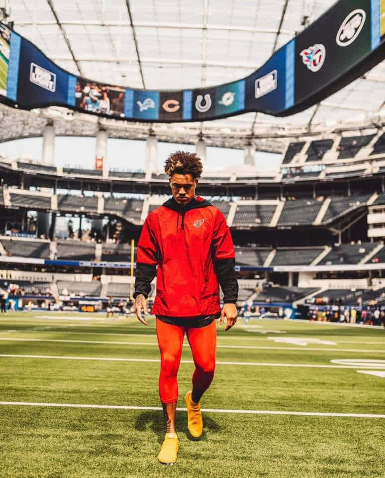 Byron Murphy, bright red gear, sunlit stadium field, SD Phone Wallpaper
