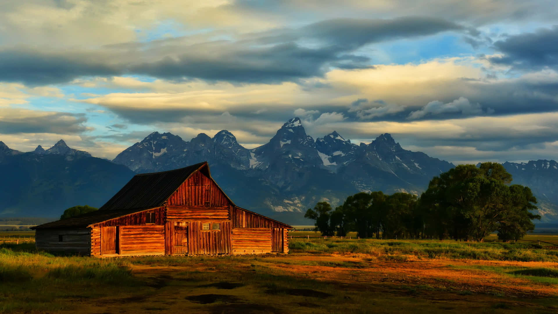 rustic wooden barn, golden sunset light, snow-capped mountain range, Full HD Desktop Wallpaper