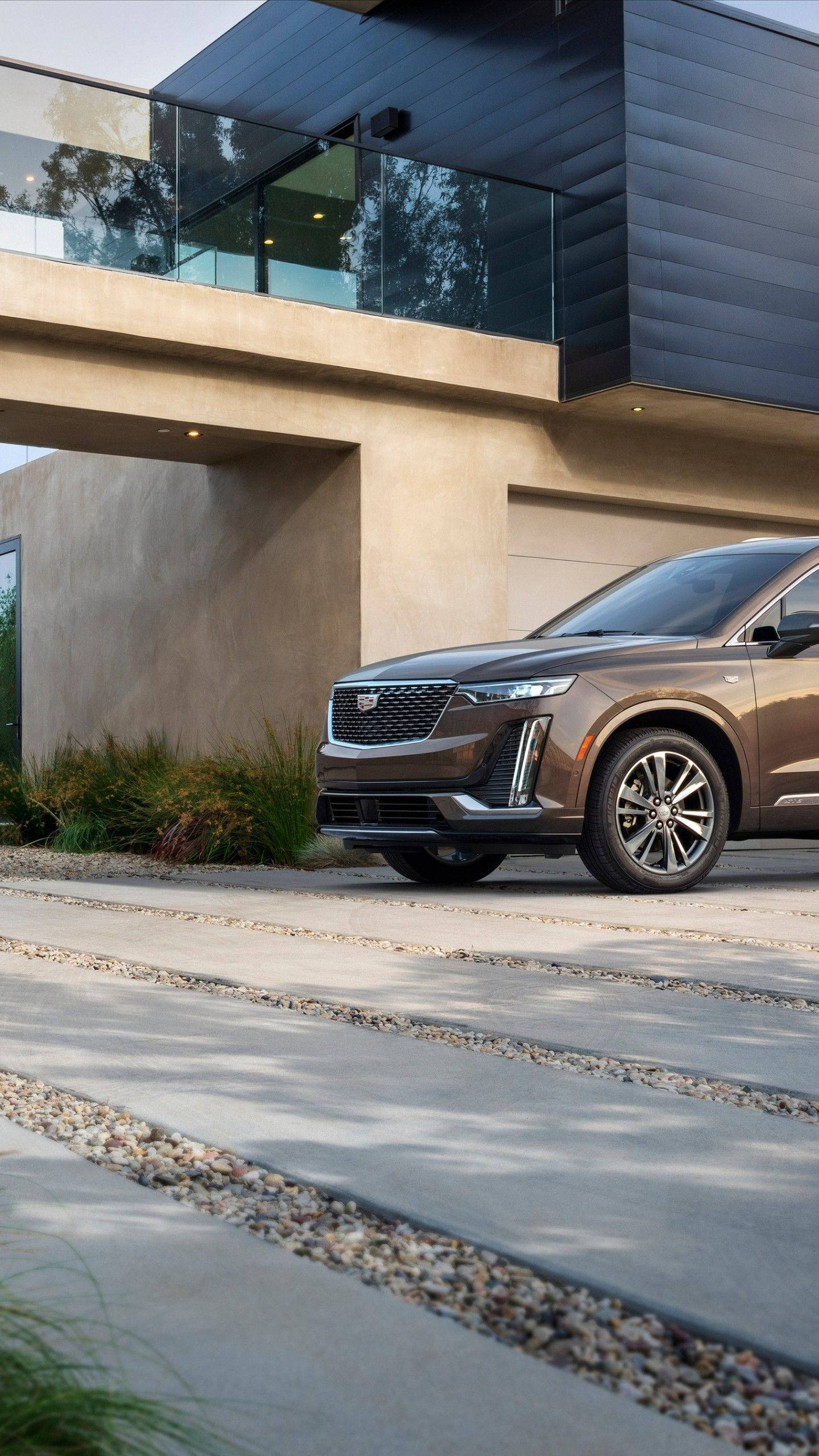 brown cadillac, bronze SUV, modern concrete driveway, 2K Phone Wallpaper