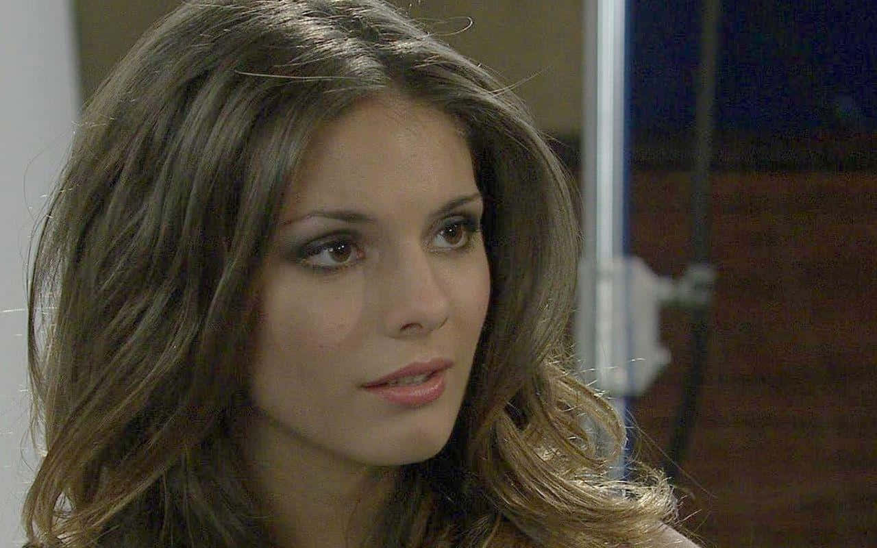 Caitlin Stasey, wavy brown hair, softly lit indoor setting, HD Desktop Wallpaper