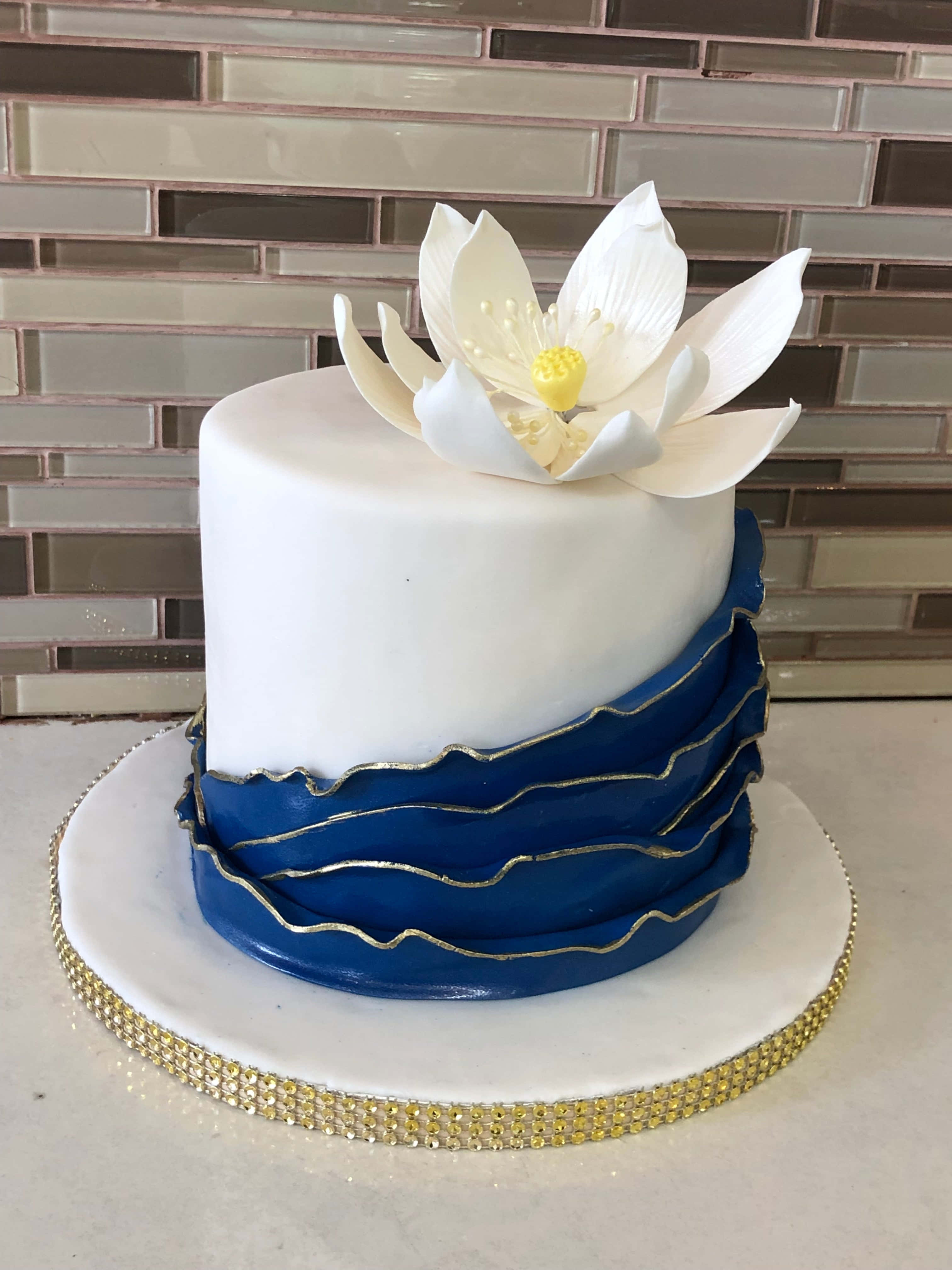 cake fondant, blue ruffled layers, white lotus flower topper, 4K Phone Wallpaper