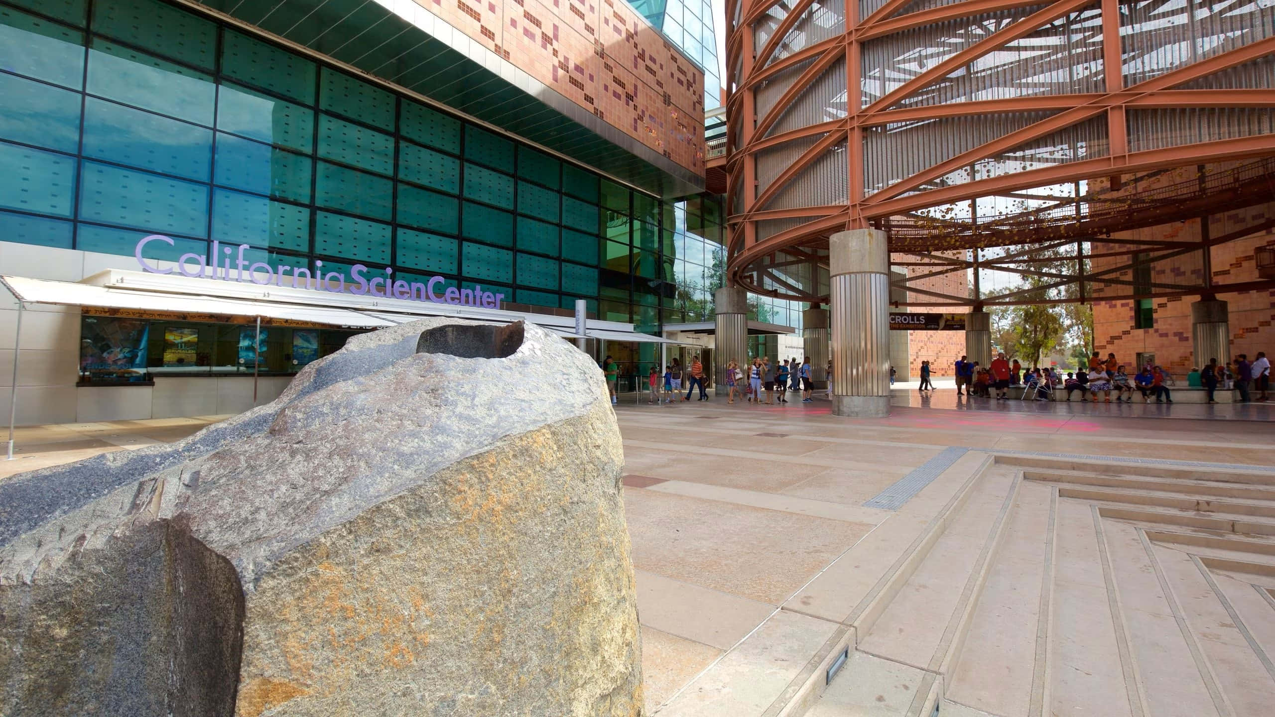 California Science Center, modern glass and copper structure, textured boulder, 2K Desktop Wallpaper