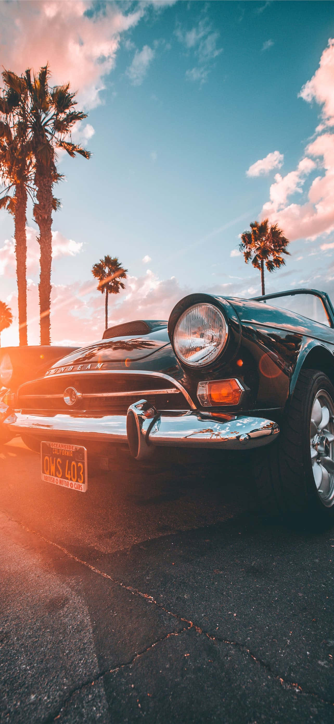 California, vintage black convertible sports car, warm sunset sky, 2K Phone Wallpaper