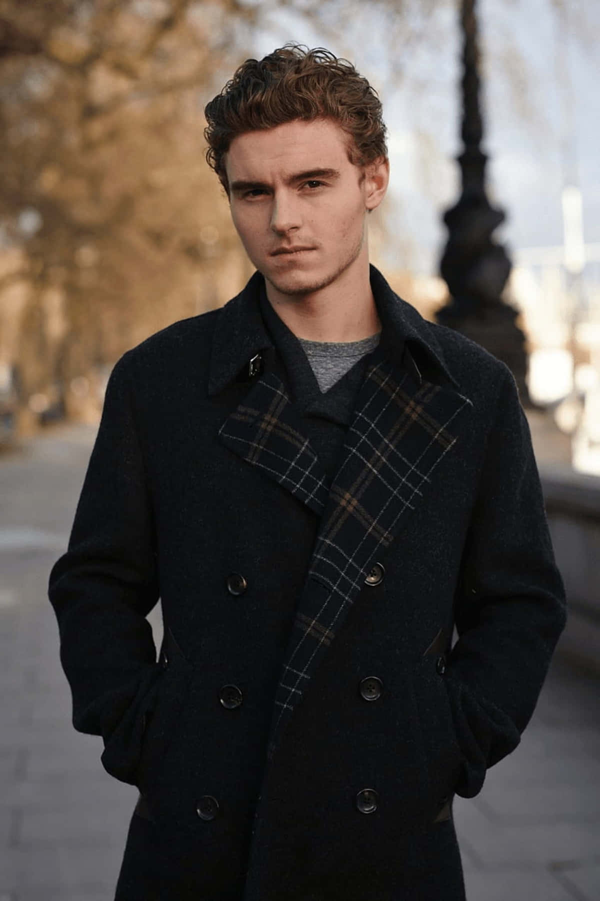 Callan Mcauliffe, dark plaid-collared coat, sunlit urban sidewalk, HD Phone Wallpaper