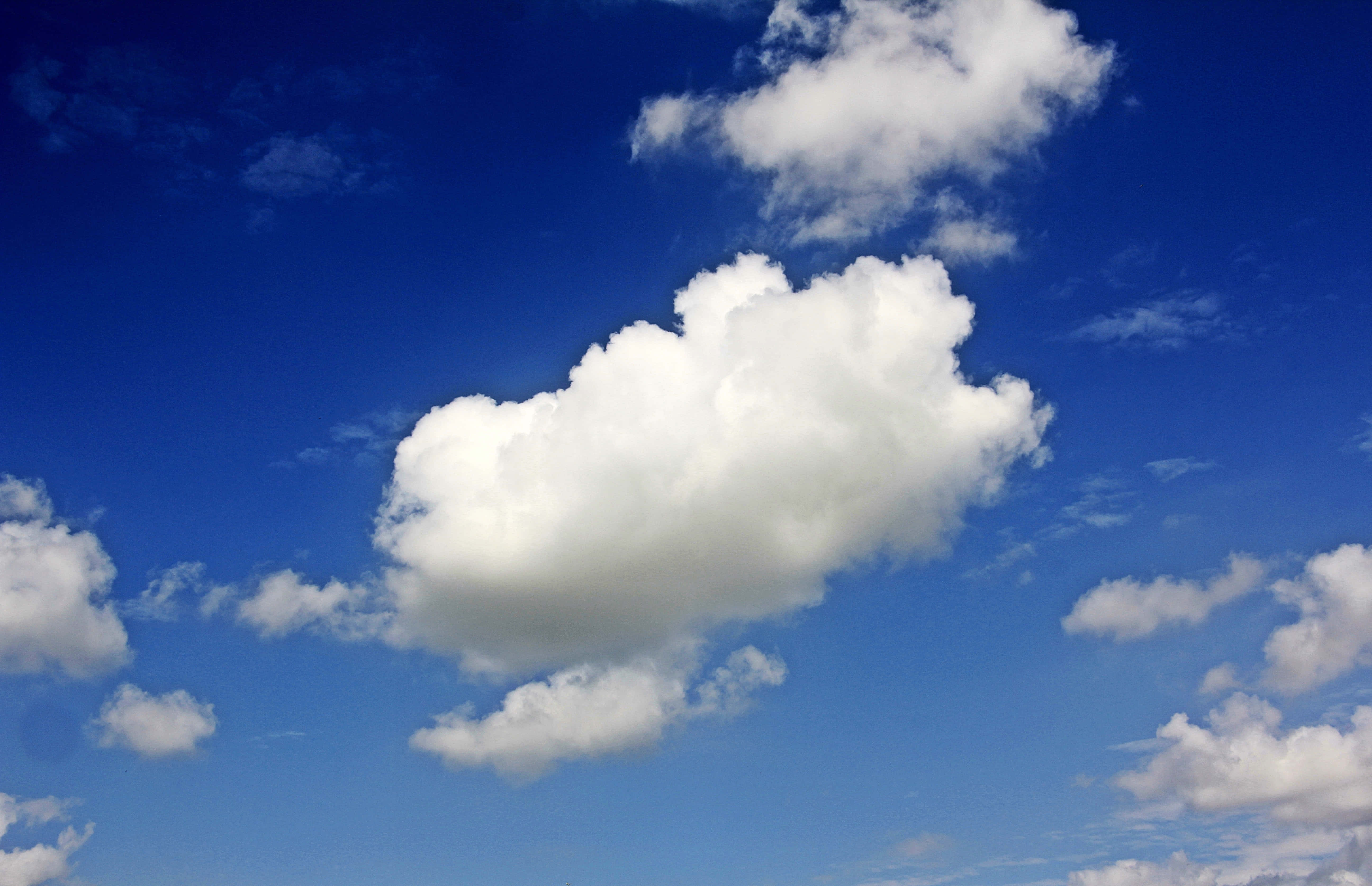 fluffy white cloud, vibrant blue sky, scattered smaller clouds, 5K Desktop Wallpaper