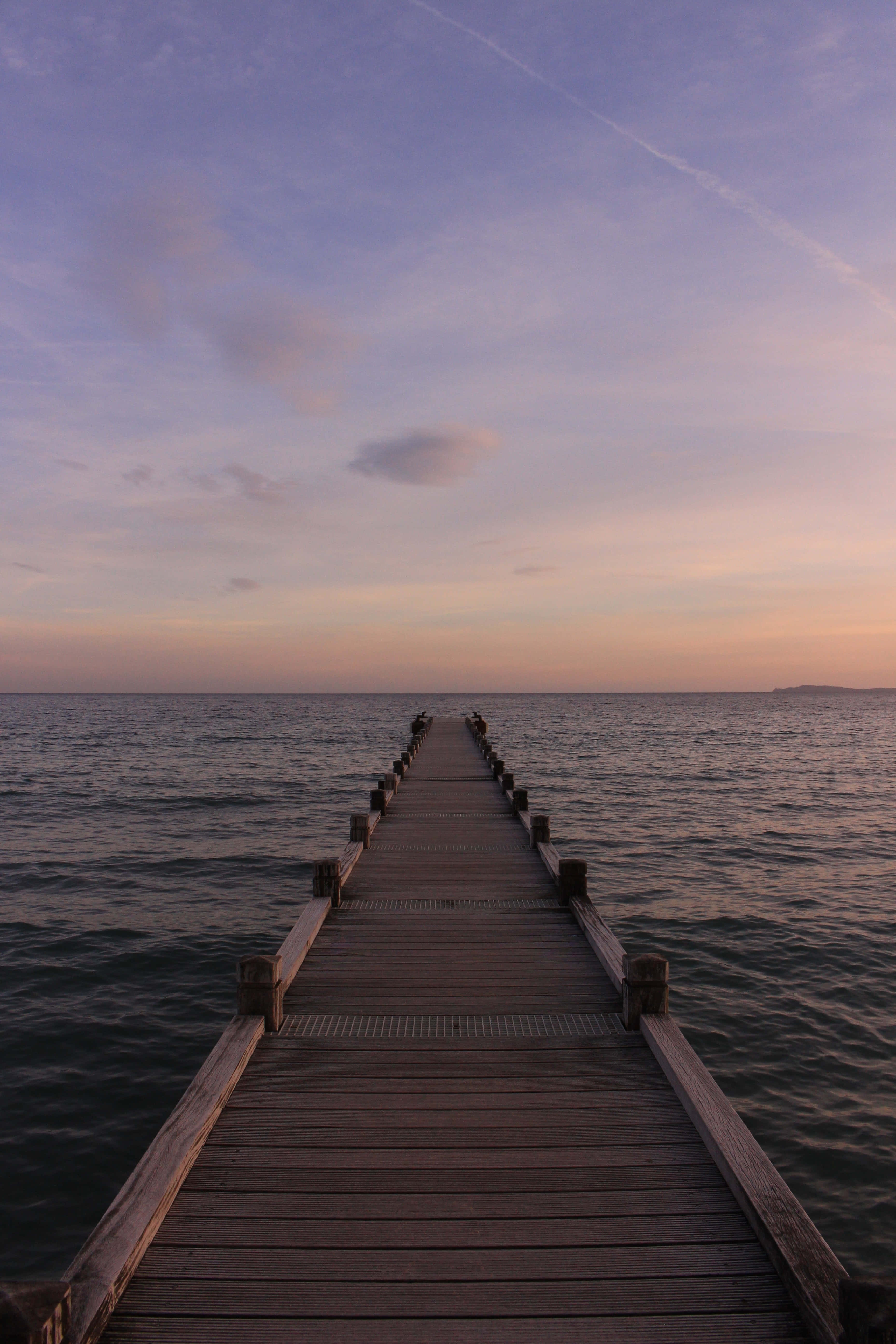 wooden pier, calm waters, purple and orange twilight sky, 5K Phone Wallpaper