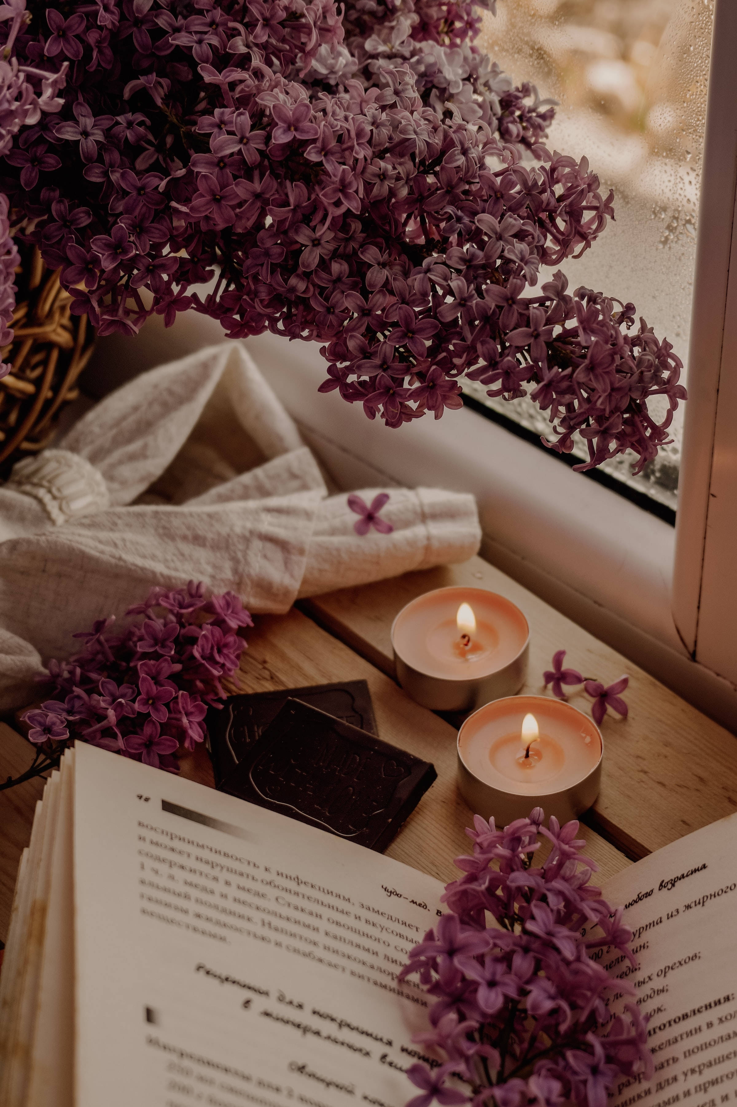 purple lilacs, candles, open book, 2K Phone Wallpaper