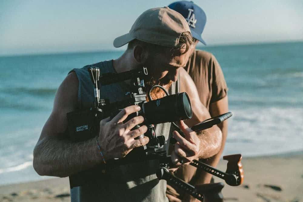 bearded cameraman, large camera, beach, SD Desktop Wallpaper