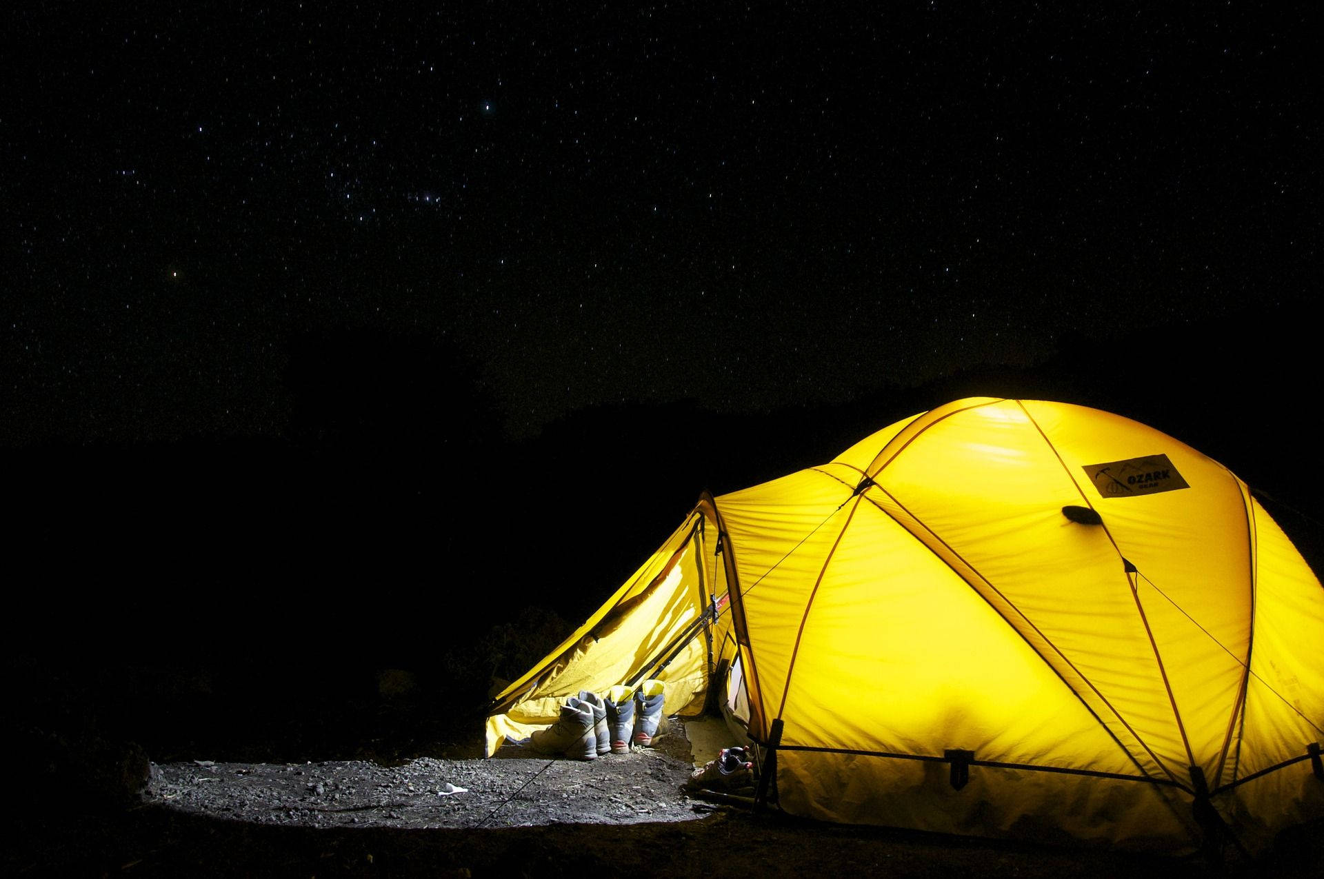 glowing yellow tent, starry night sky, dark silhouetted hills, Full HD Desktop Wallpaper
