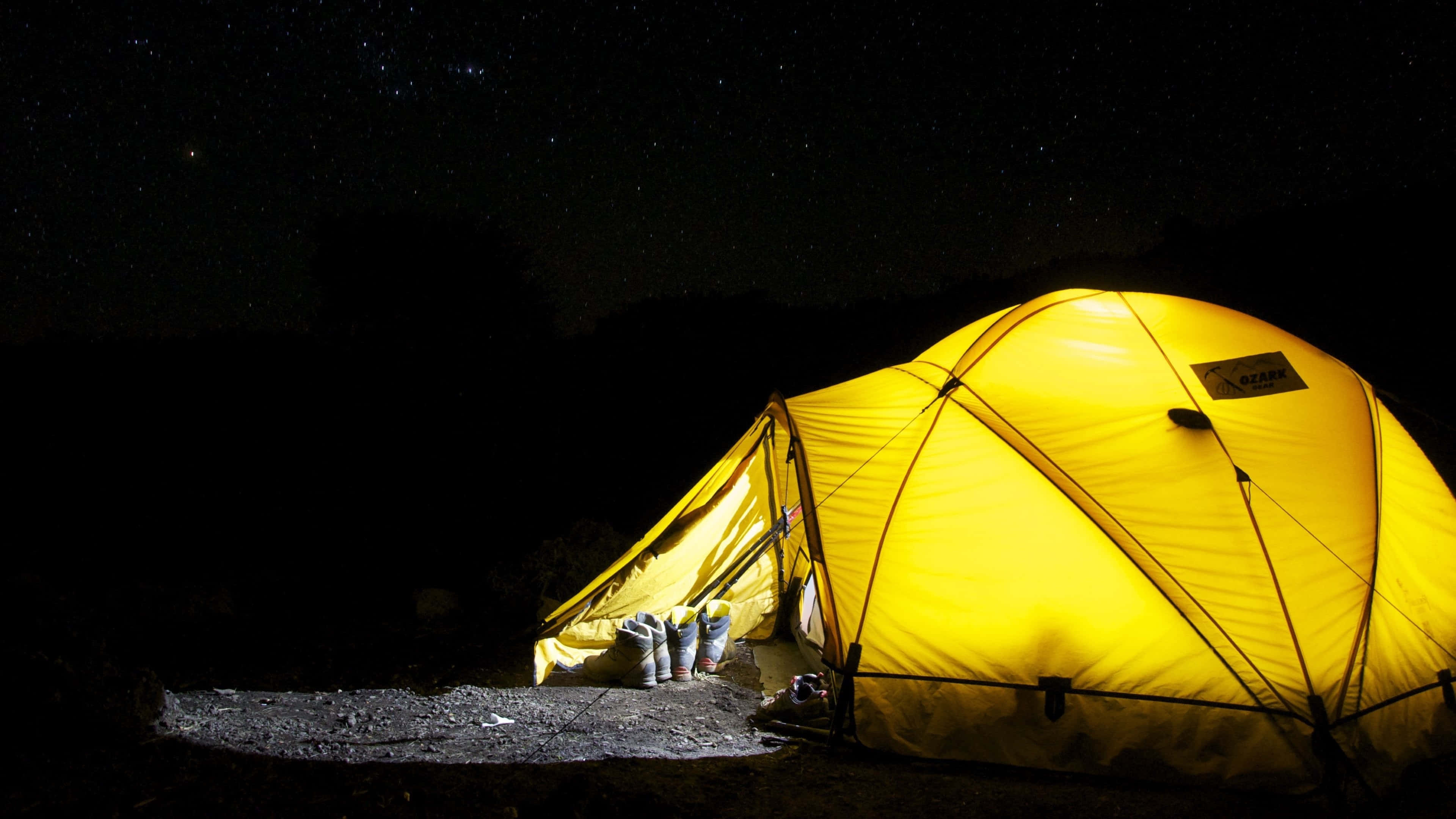 Pitch Black Night Camping Desktop, glowing yellow tent, gravel campsite, 4K Desktop Wallpaper
