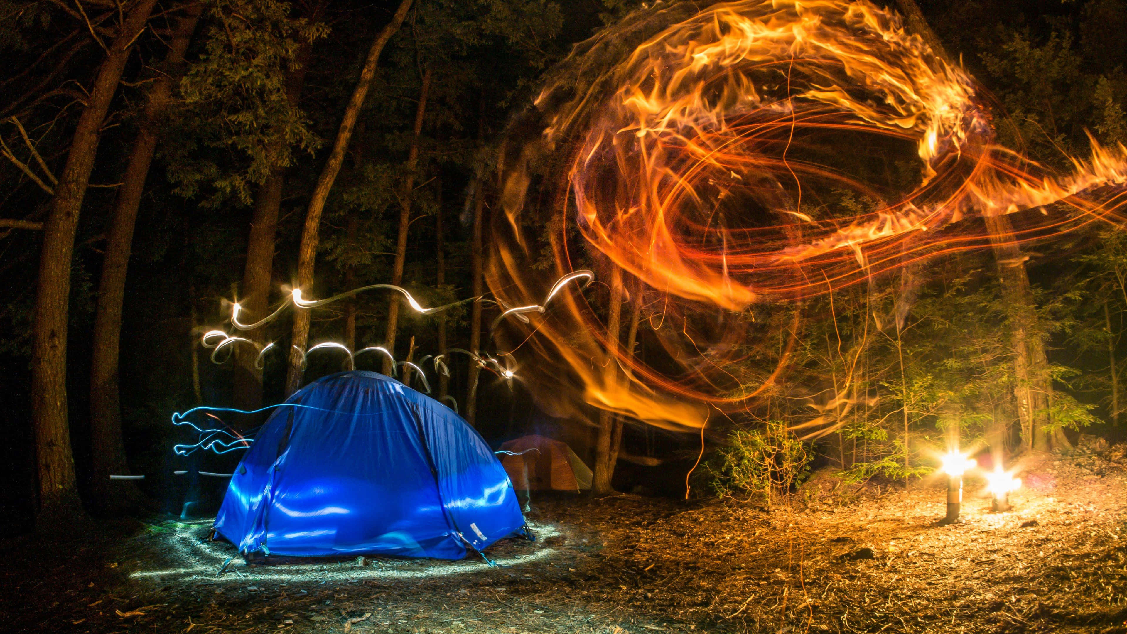 glowing blue tent, dark forest at night, swirling fiery light trails, 4K Desktop Wallpaper