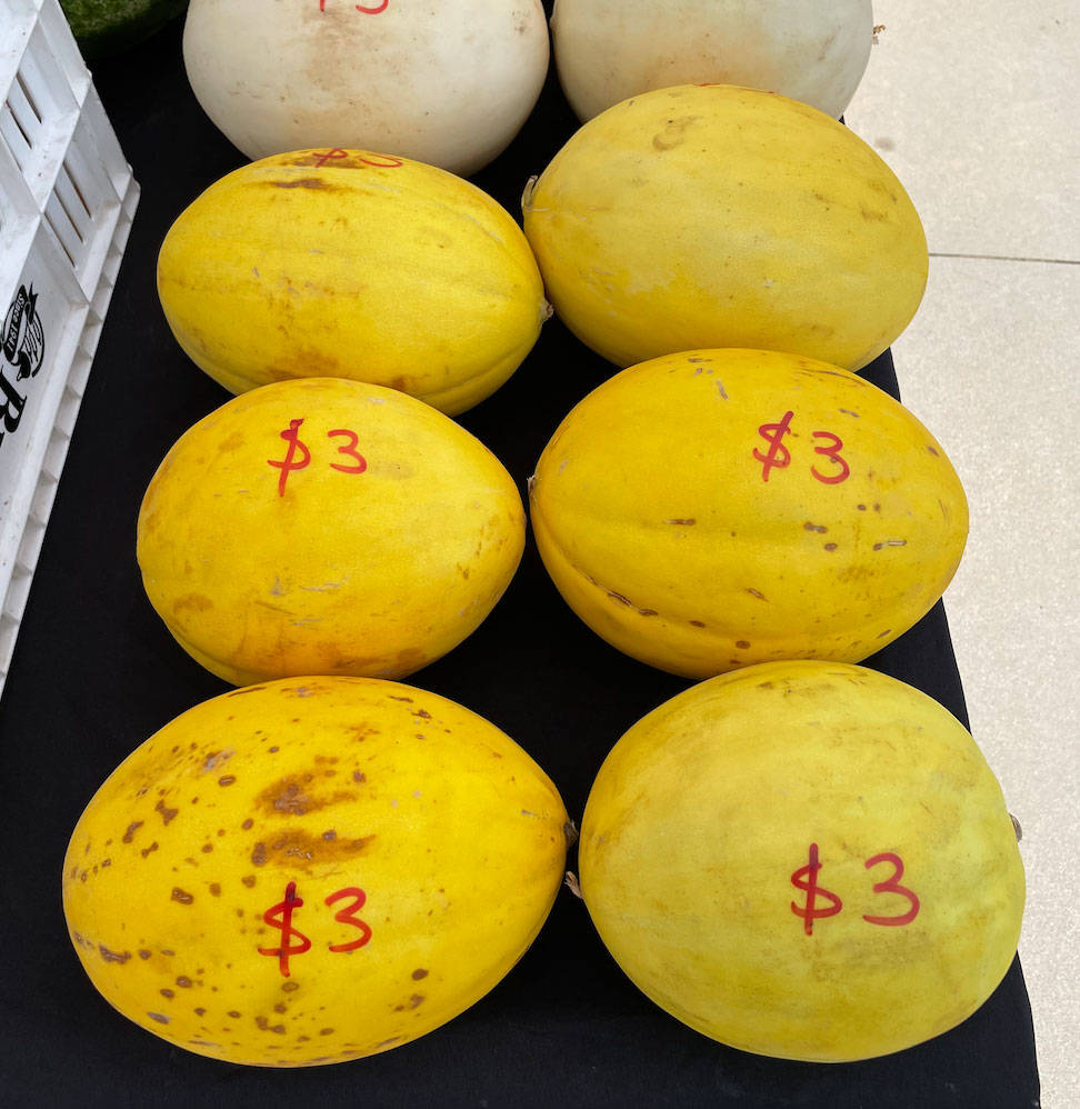 Canary Melon, red $3 price tags, black surface, SD Phone Wallpaper