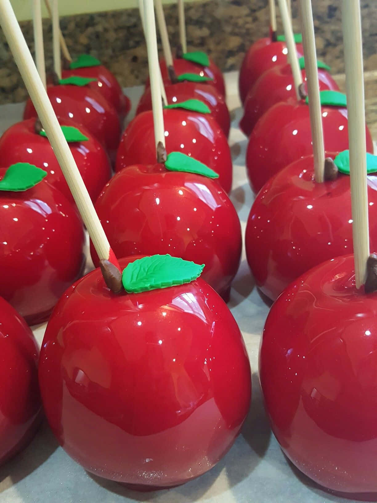 Candy Apples, glossy red caramel apples, green leaves, HD Phone Wallpaper