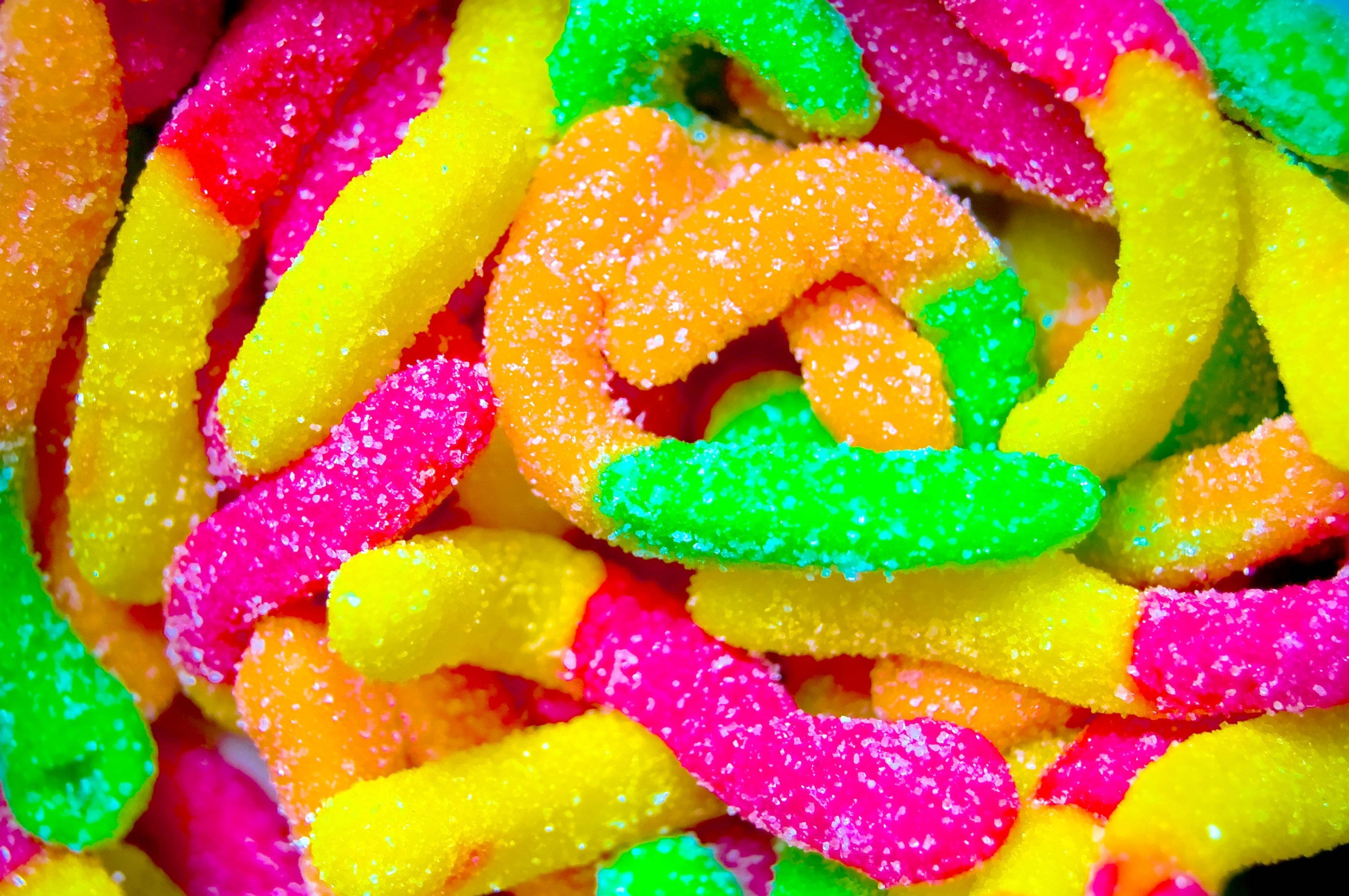 sour gummy worm candies, neon pink, yellow, 2K Desktop Wallpaper