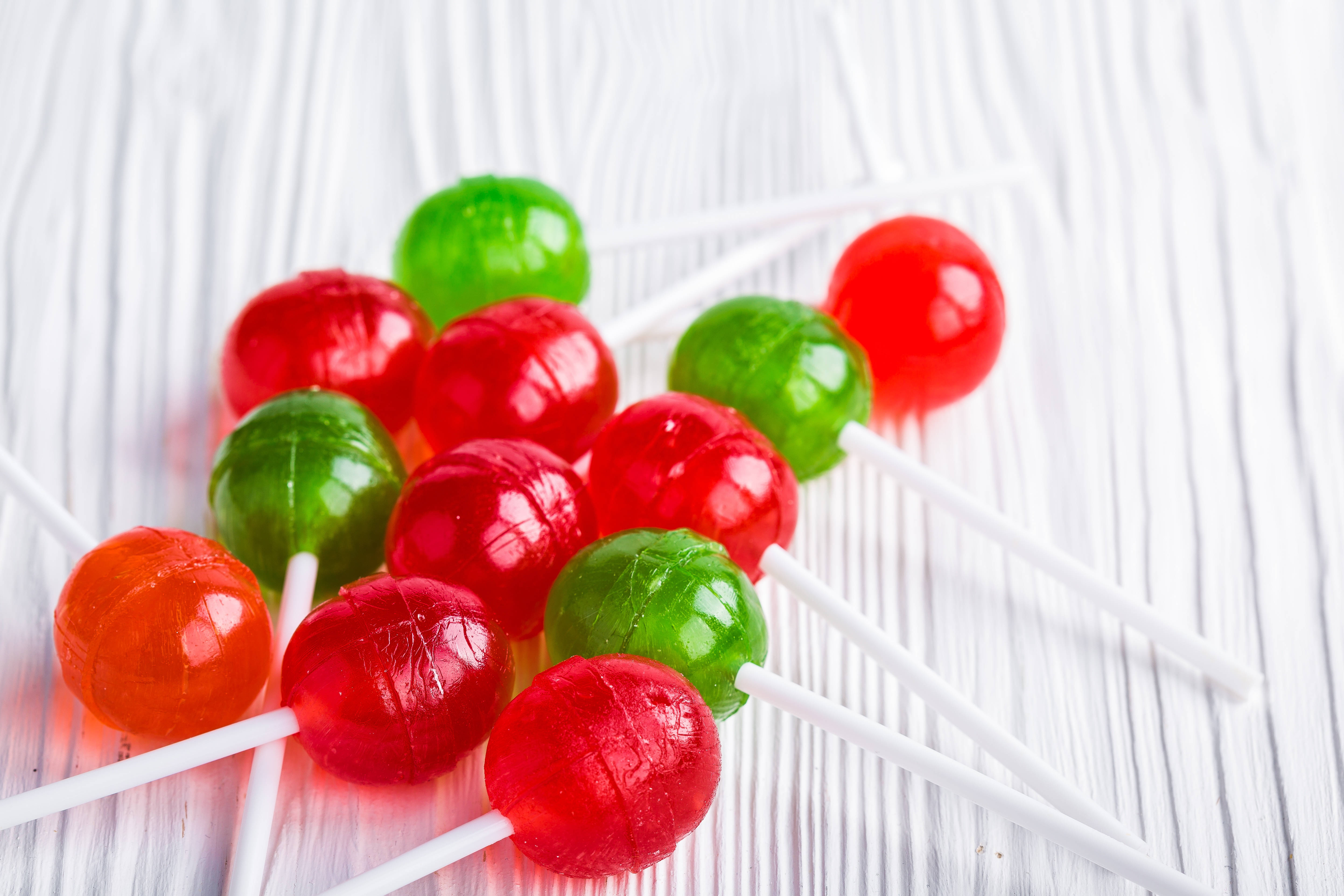 tasty lollipop candies, vibrant red, green gummy lollipops, 5K Desktop Wallpaper