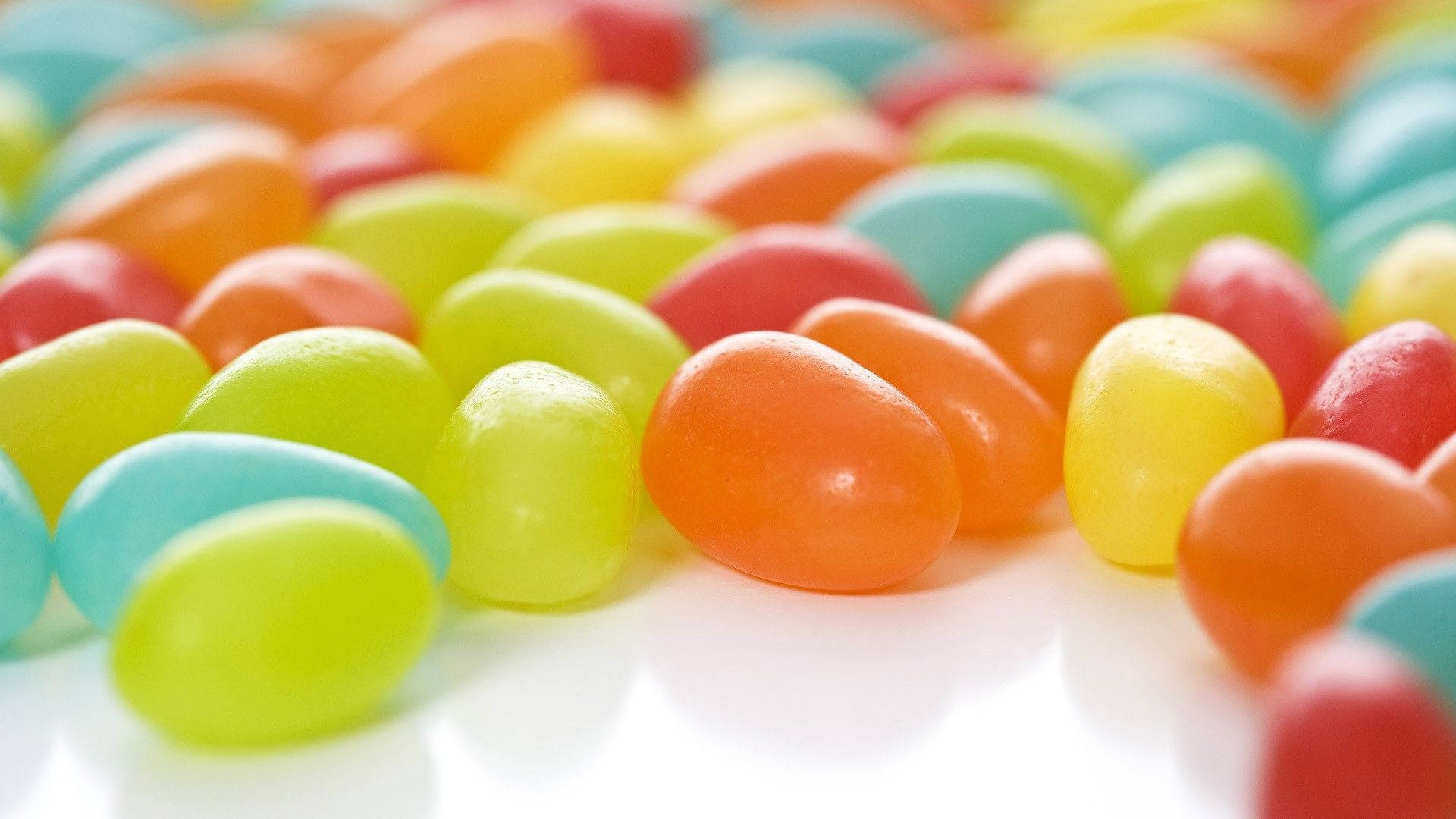 radiant jelly bean candies, bright candy colors, clean white surface, Full HD Desktop Wallpaper