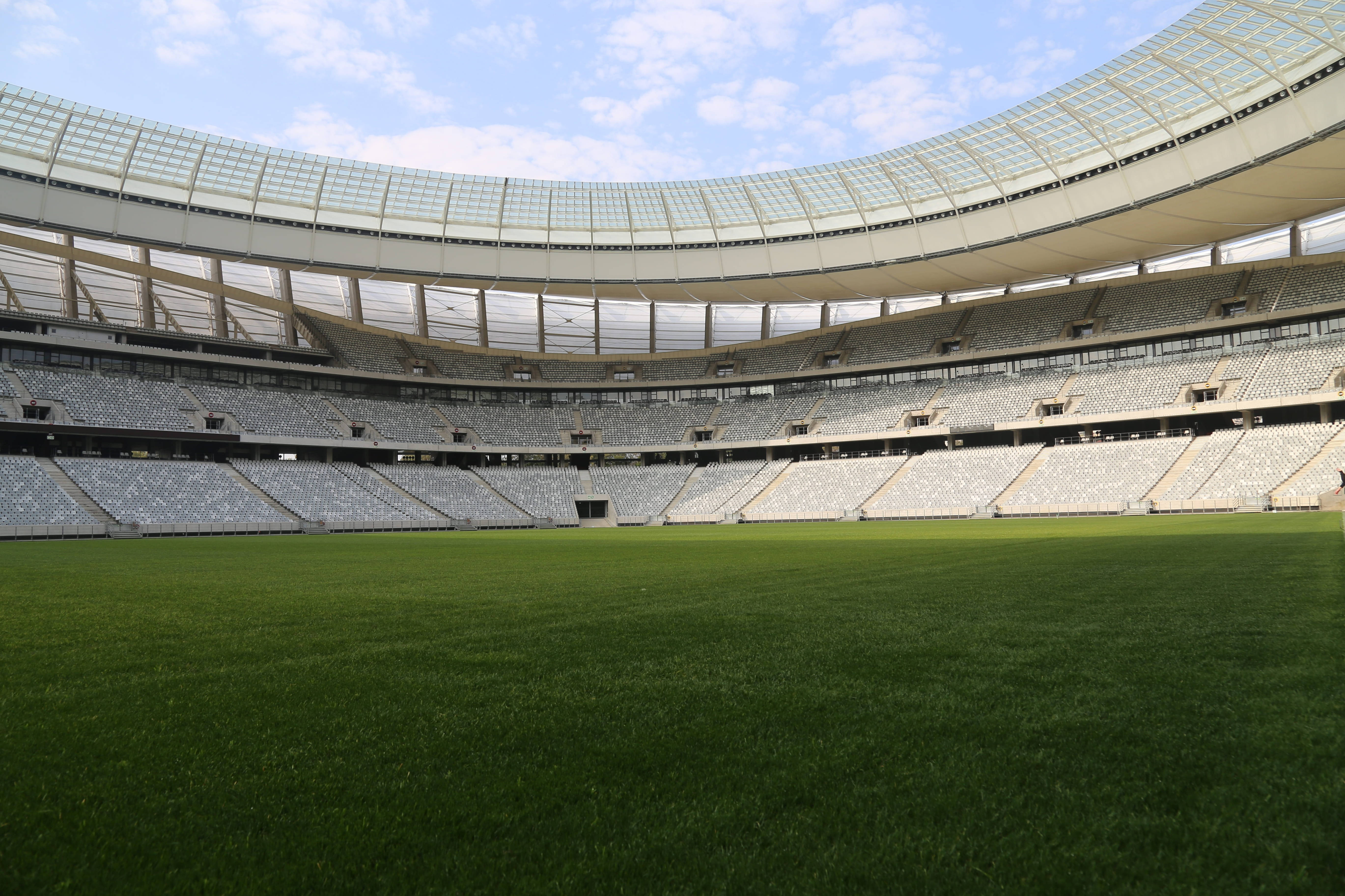 Cape Town Stadium, lush green field, tiered white seats, 5K Desktop Wallpaper
