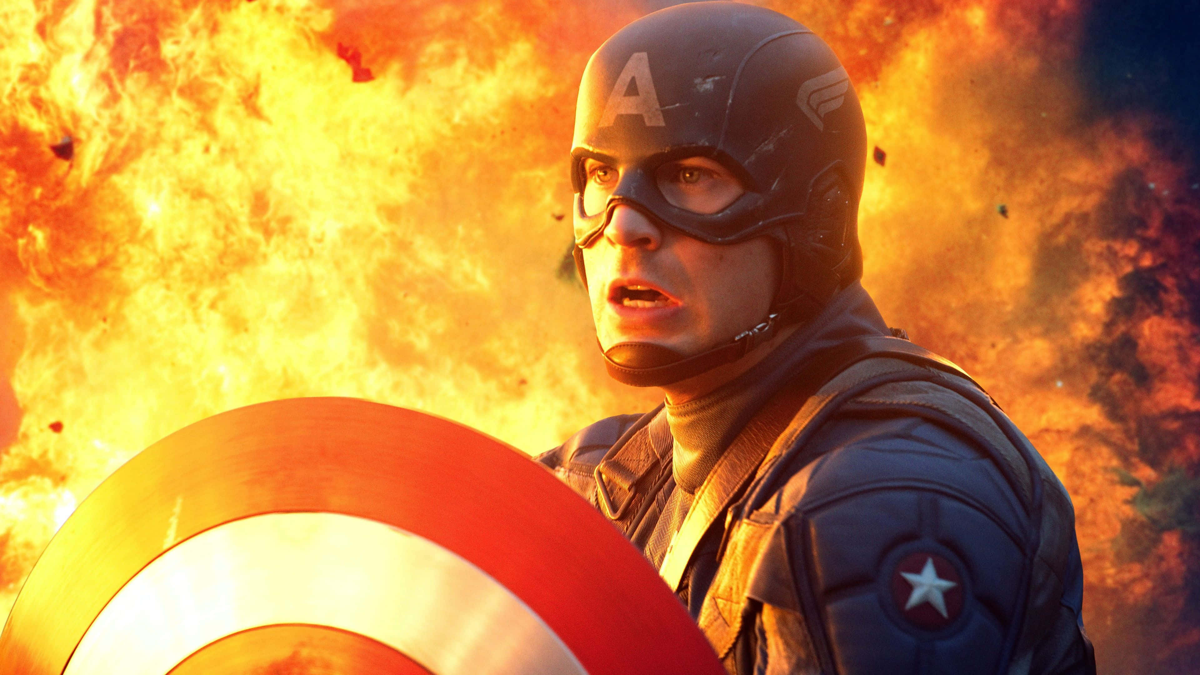 Captain America, iconic shield, roaring orange flames, 4K Desktop Wallpaper