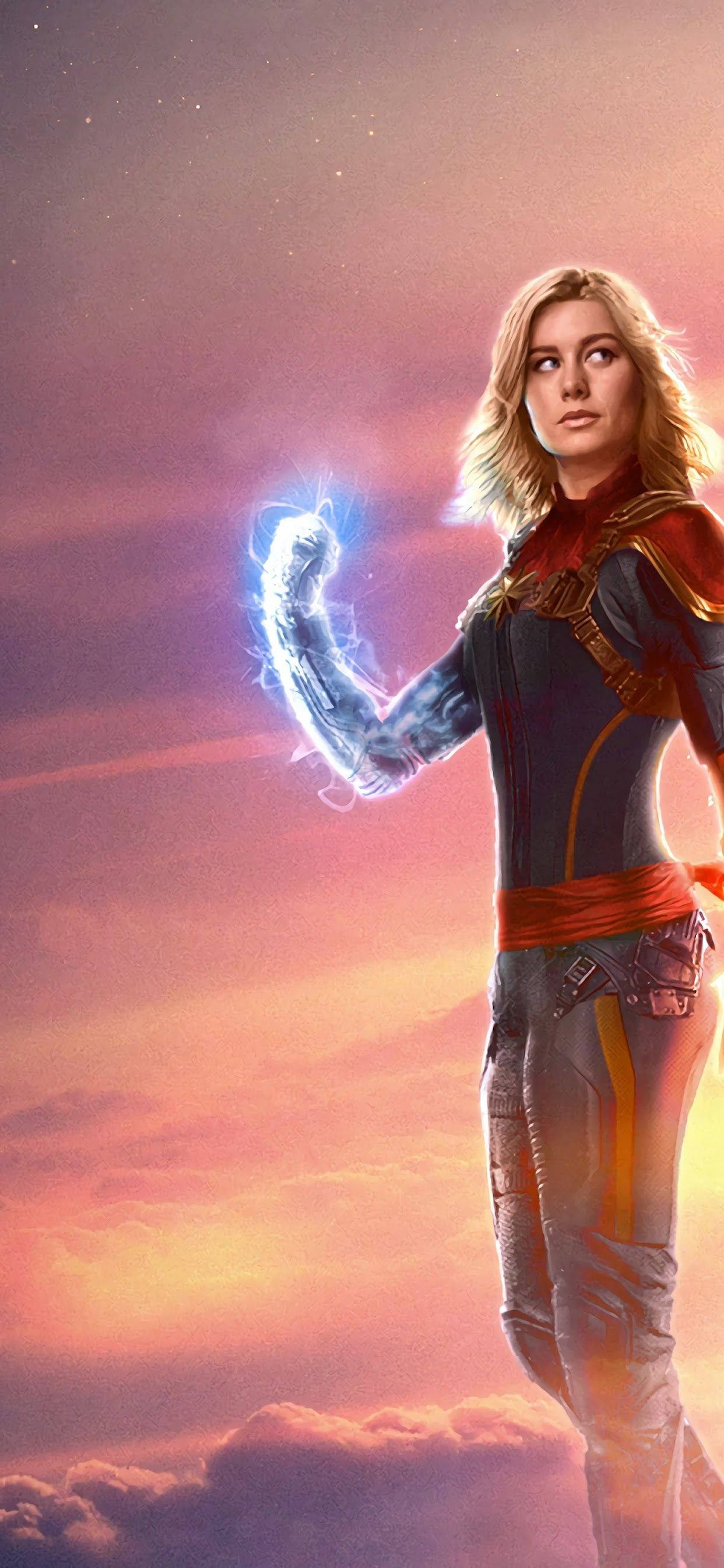 Captain Marvel, vibrant sunset sky, cosmic energy, 2K Phone Wallpaper