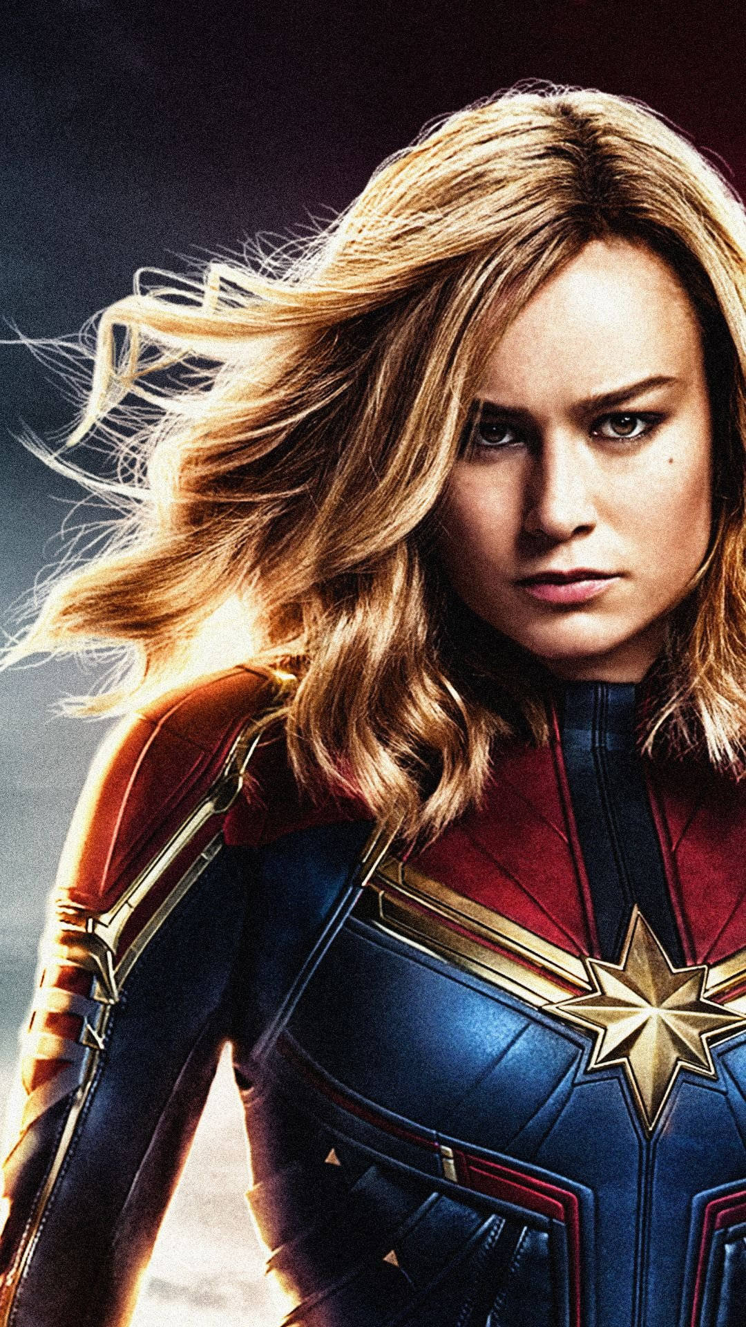 Captain Marvel, blue red and gold suit, wind-swept blonde hair, Full HD Phone Wallpaper