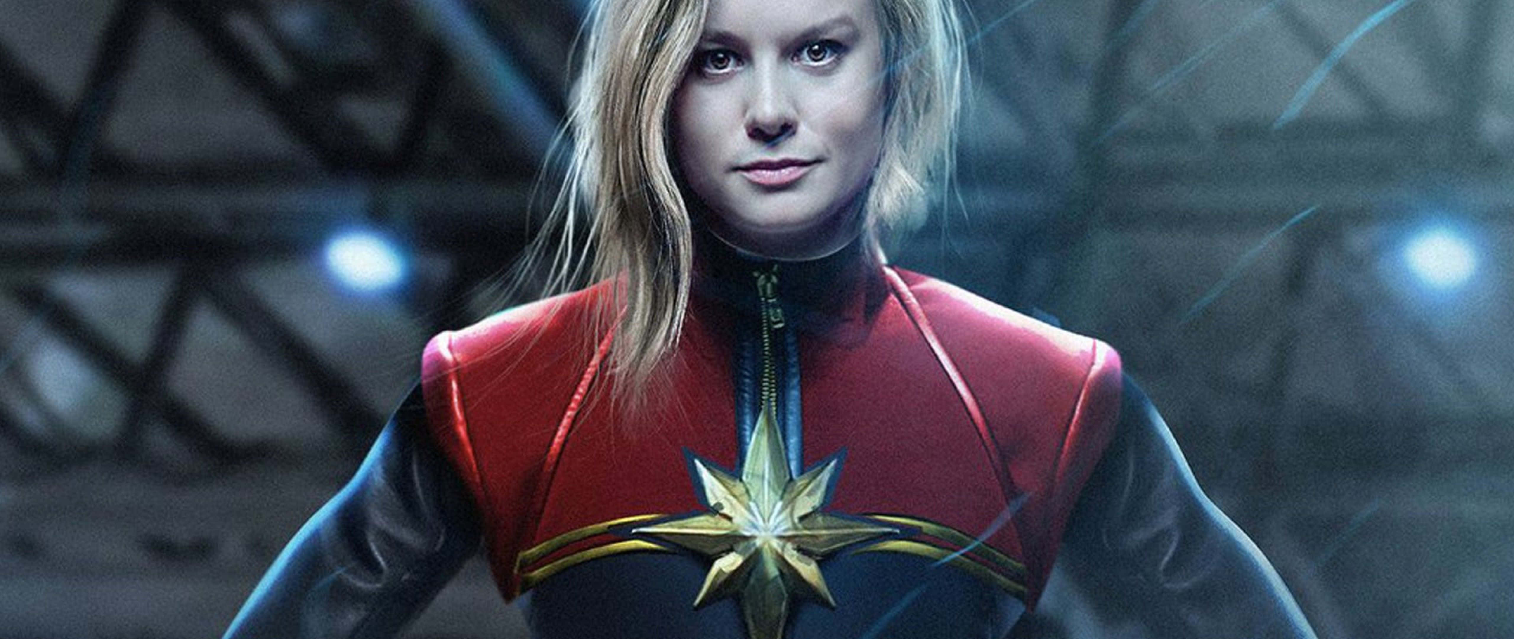 Captain Marvel, red and blue suit, glowing star emblem, 5K Desktop Wallpaper