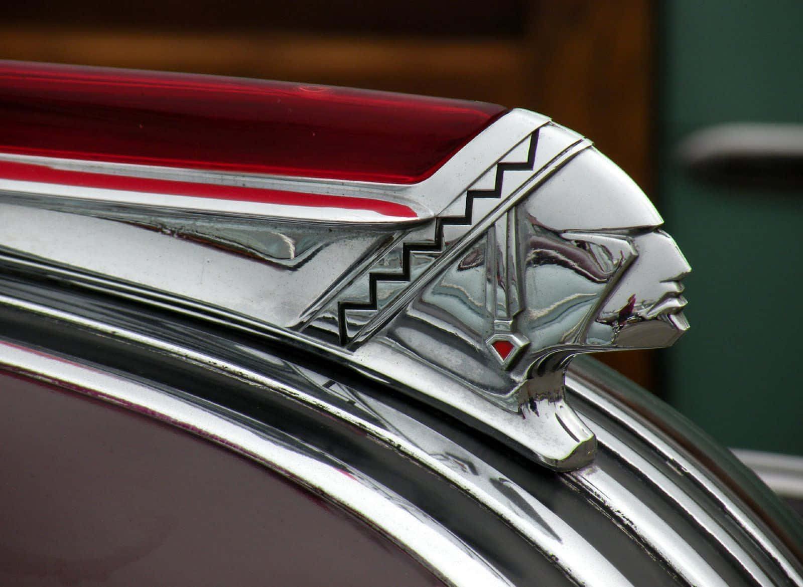 chrome hood ornament, stylized Native American chief, red accents, HD Desktop Wallpaper