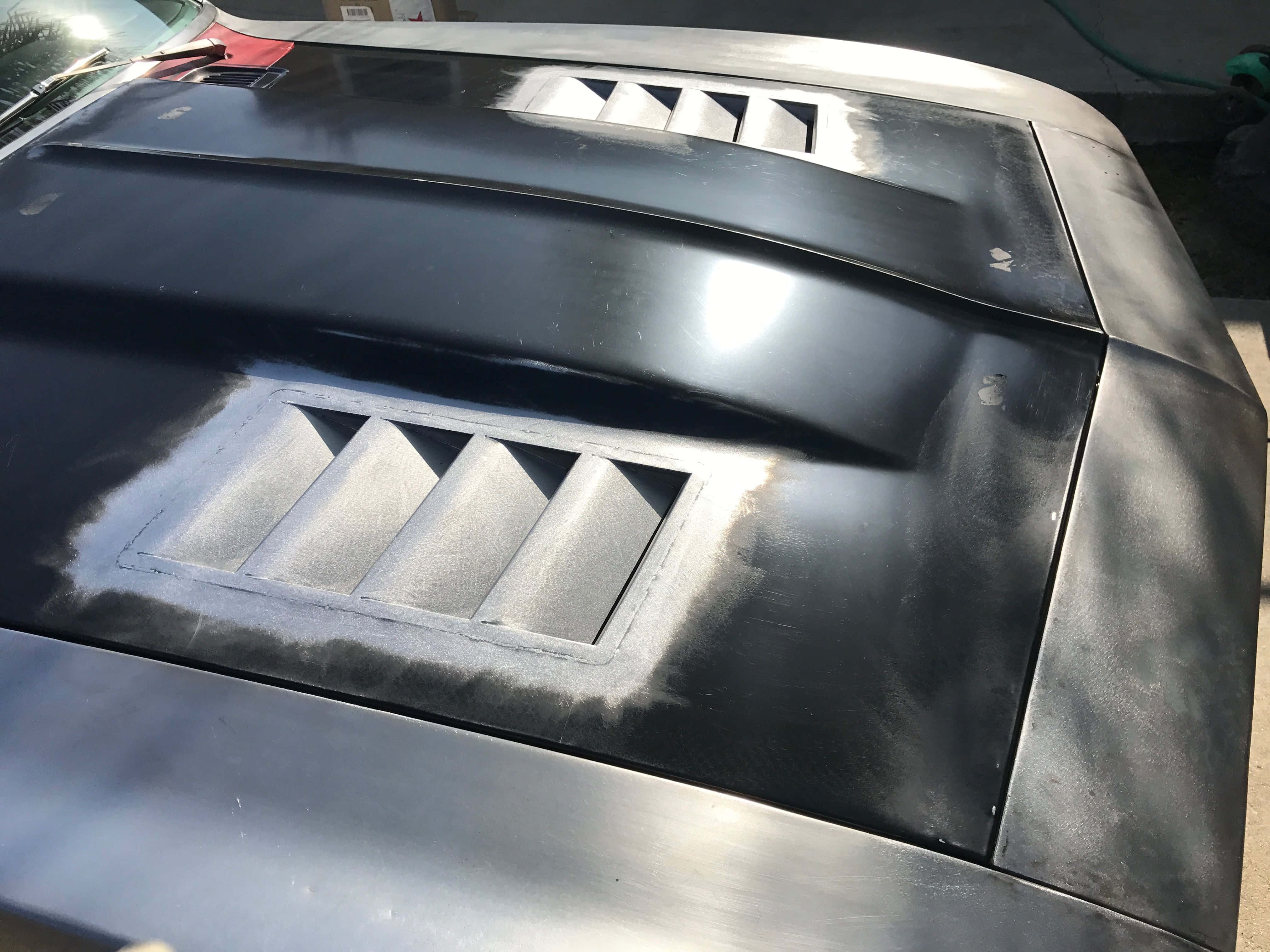 sleek black car hood, silver vents, bright sunlight, 4K Desktop Wallpaper