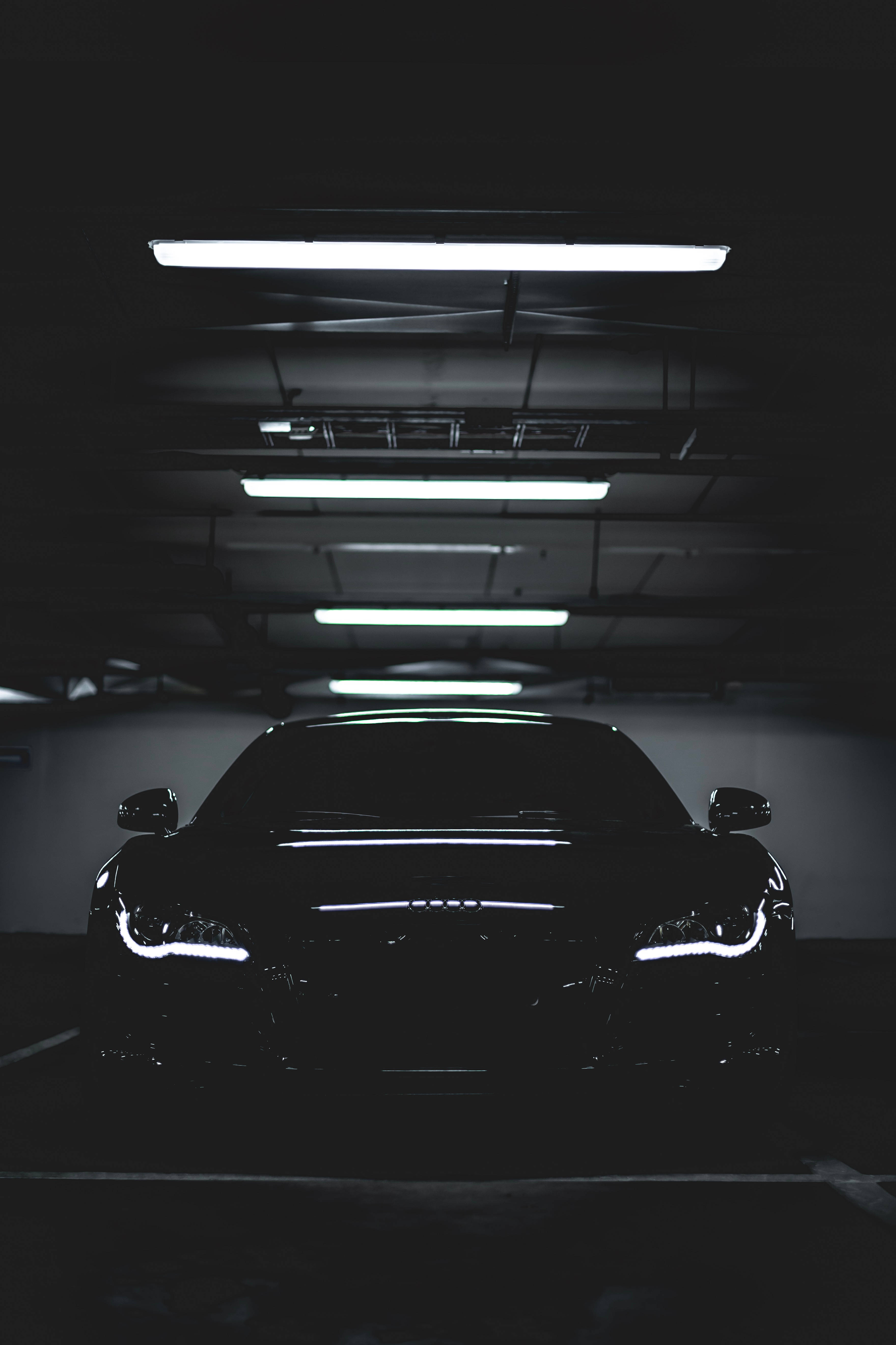 black sports car, fluorescent lights, dim underground parking garage, 5K Phone Wallpaper