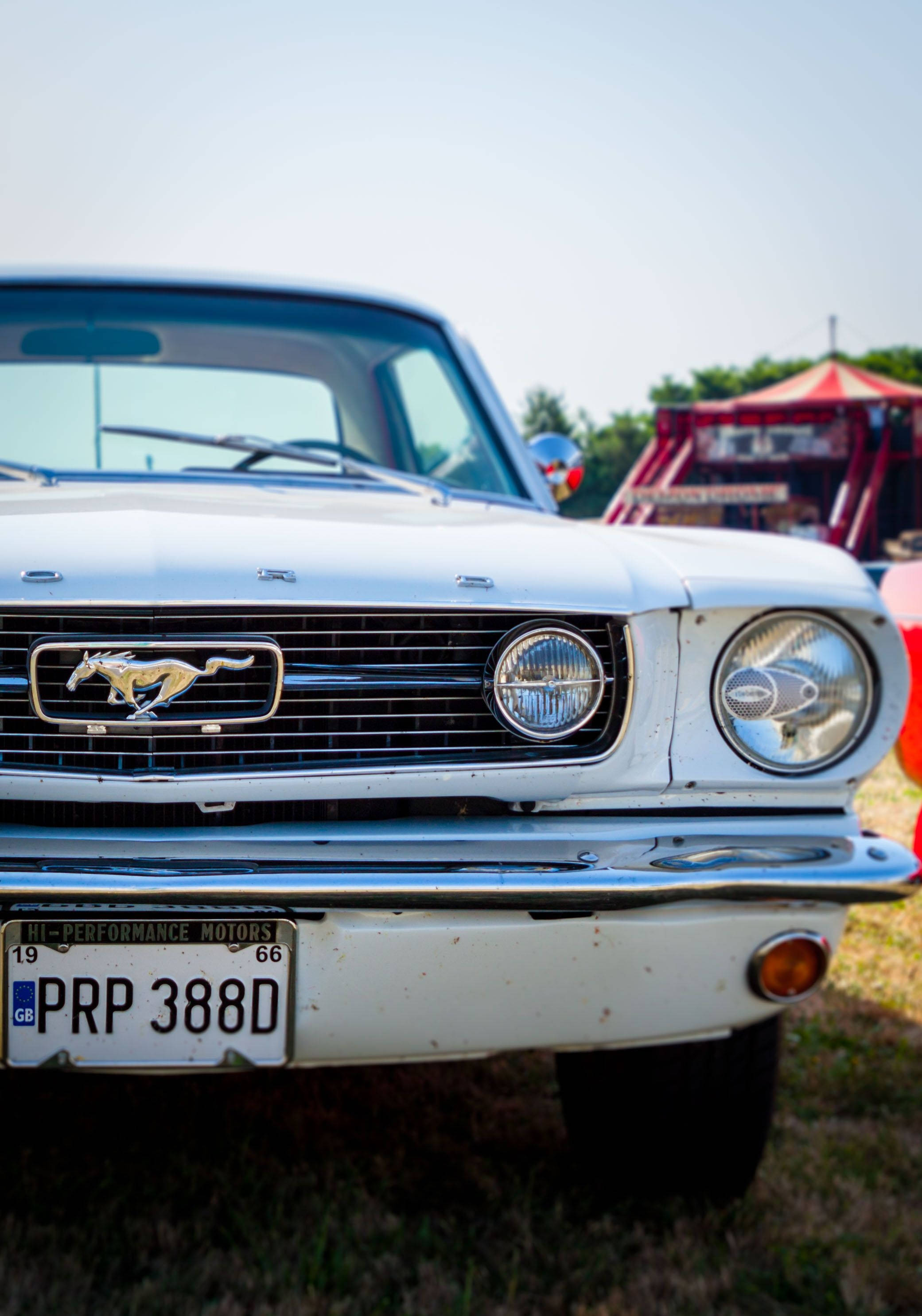 white classic Ford Mustang, chrome grille, iconic galloping horse emblem, 2K Phone Wallpaper