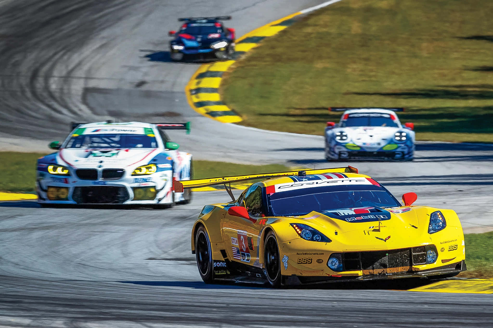 Car Racing, sunlit track corner, yellow and black curbing, Full HD Desktop Wallpaper