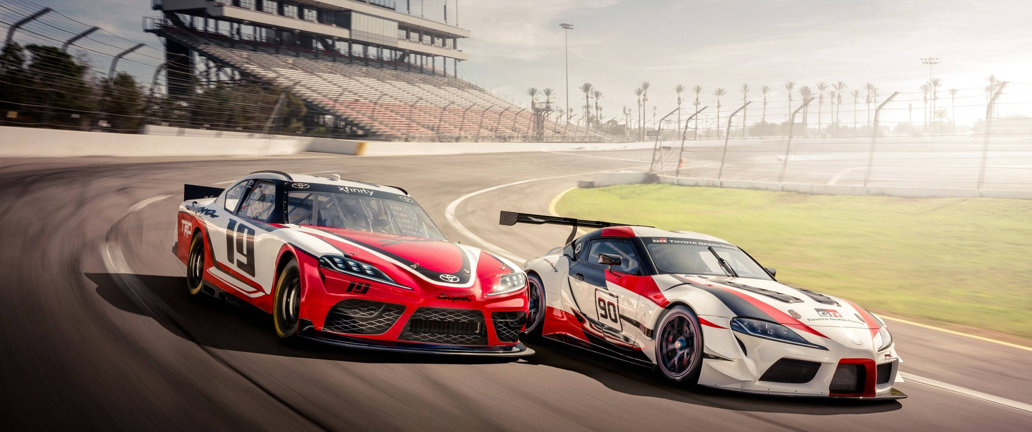 red and white livery, sunlit racetrack, grandstands, 2K Desktop Wallpaper