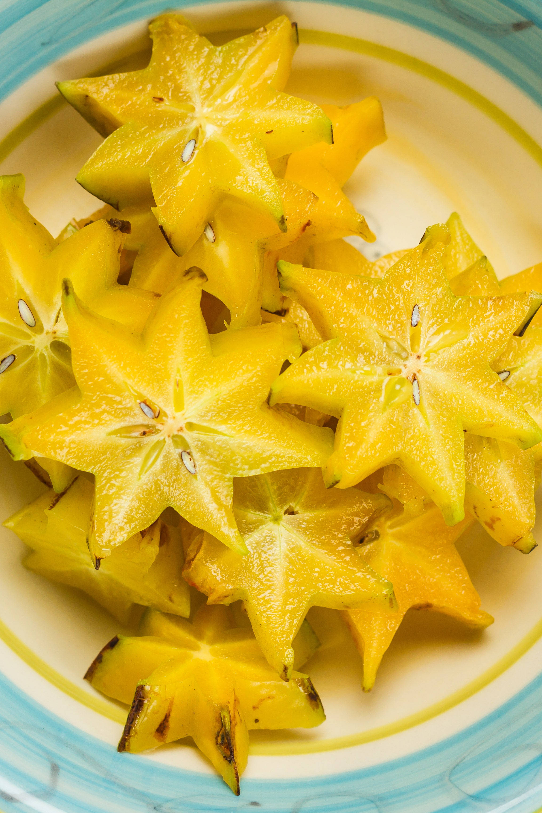 starfruit, star-shaped flesh, vibrant yellow, 2K Phone Wallpaper