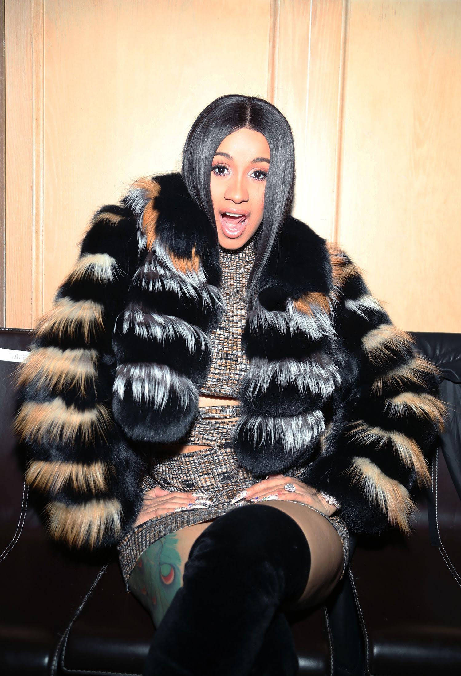 Cardi B, black tan and white fur coat, black leather couch, Full HD Phone Wallpaper