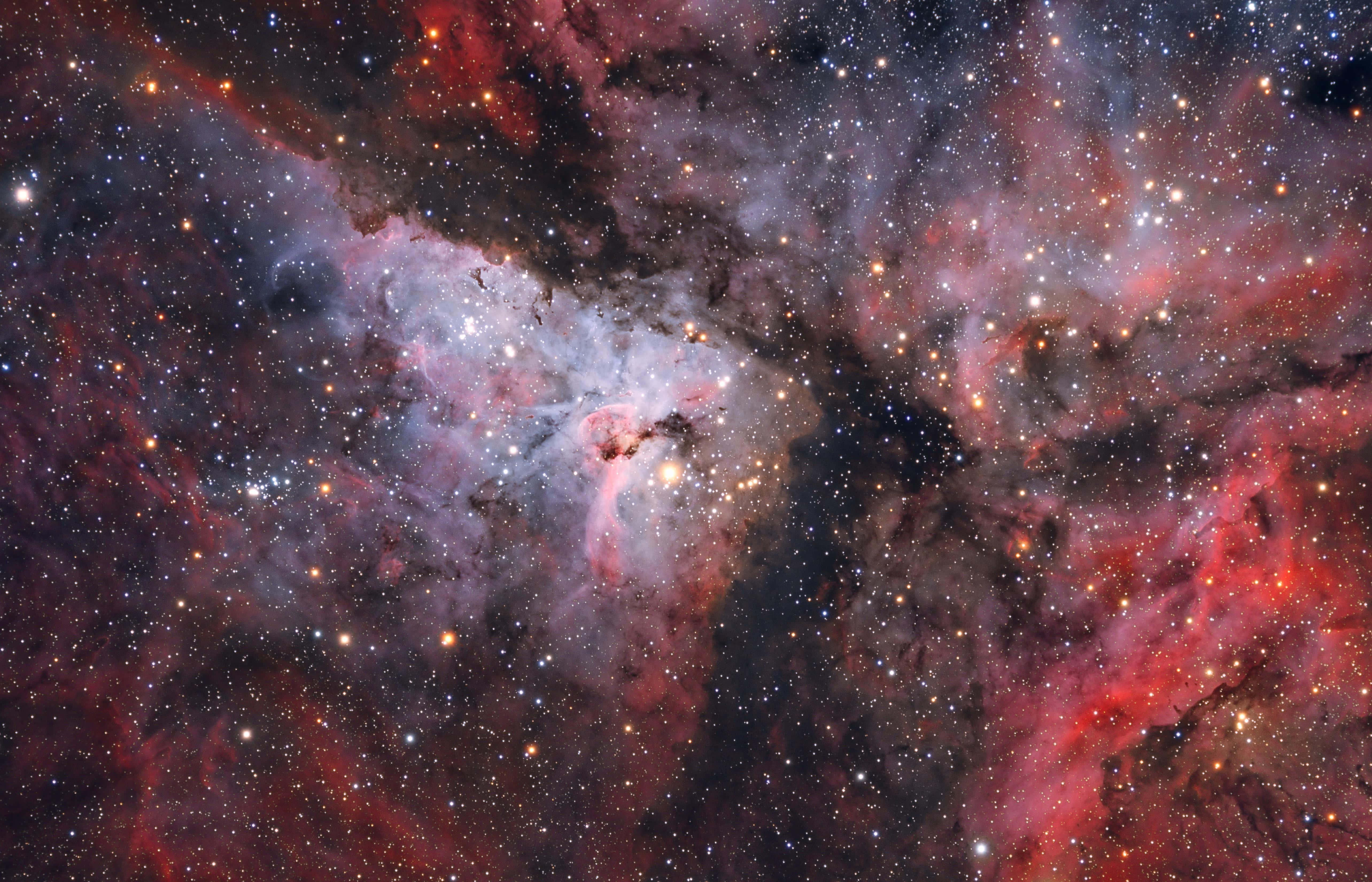 Carina Nebula, red pink and blue gases, glowing stars, 5K Desktop Wallpaper